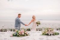 Bride and groom chcking out the table settings for their desination wedding in Italy