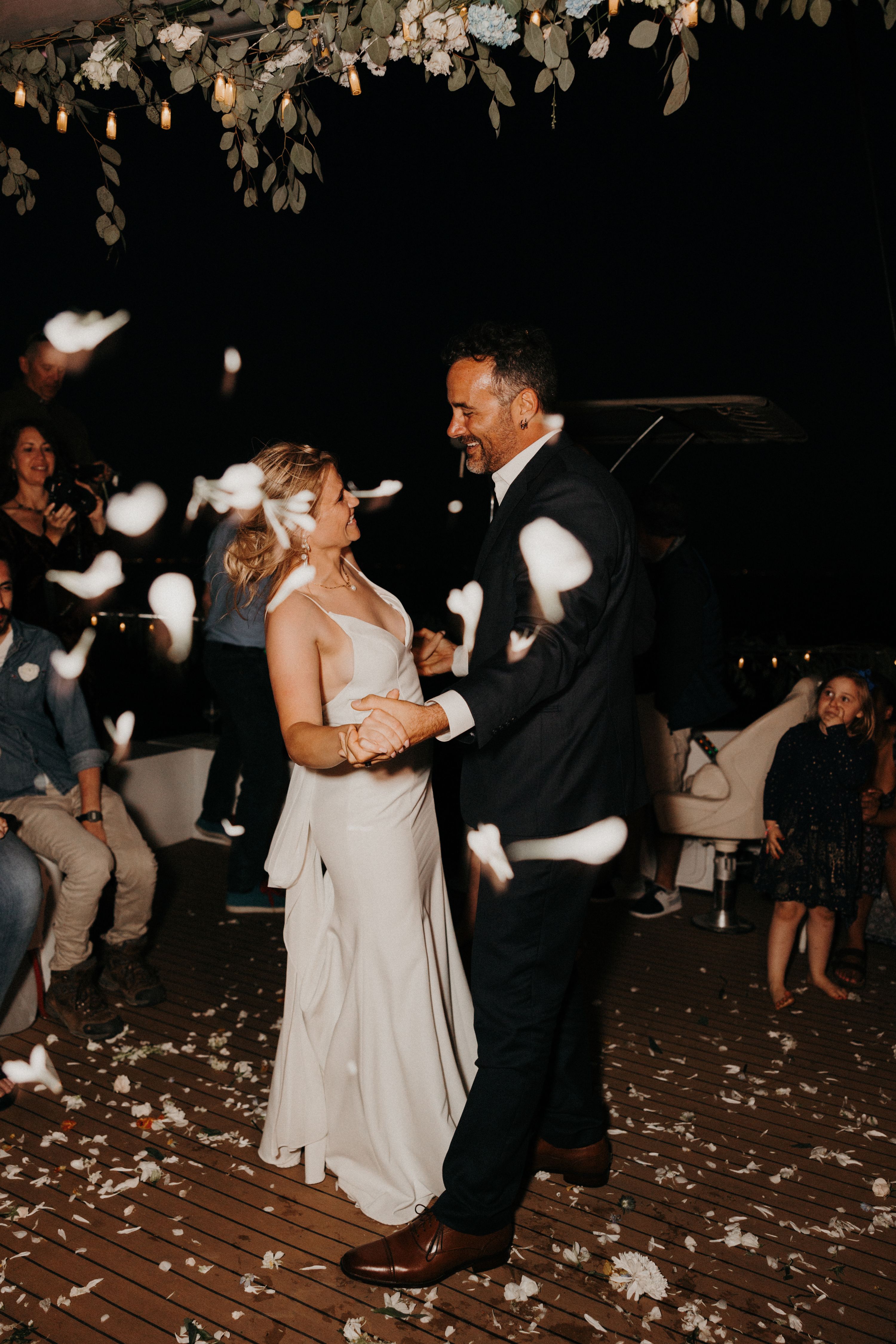 Bride and groom dancing surrounded by their guests