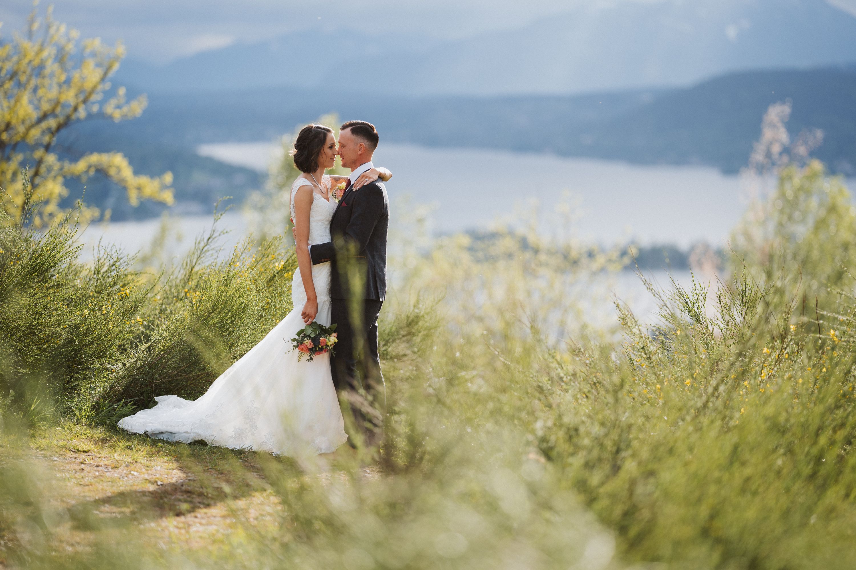 Couple kissing on a hillside path high above a Carinthian lake in spring