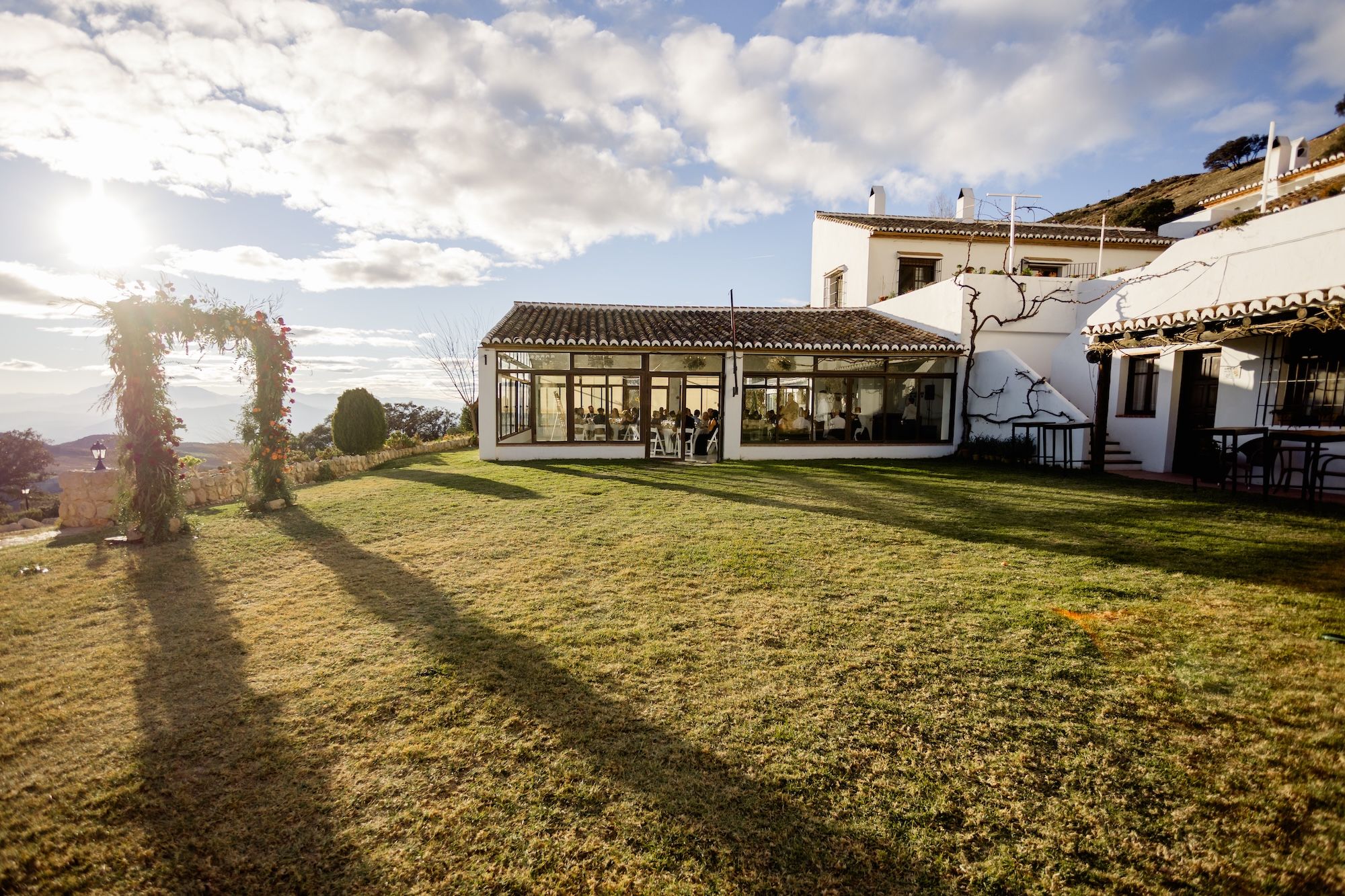 A wide shot of a reception area with glass walls under a bright blue sky in Spain