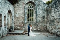 Bride and groom posing in an abbey ruin at their destination wedding in Ireland