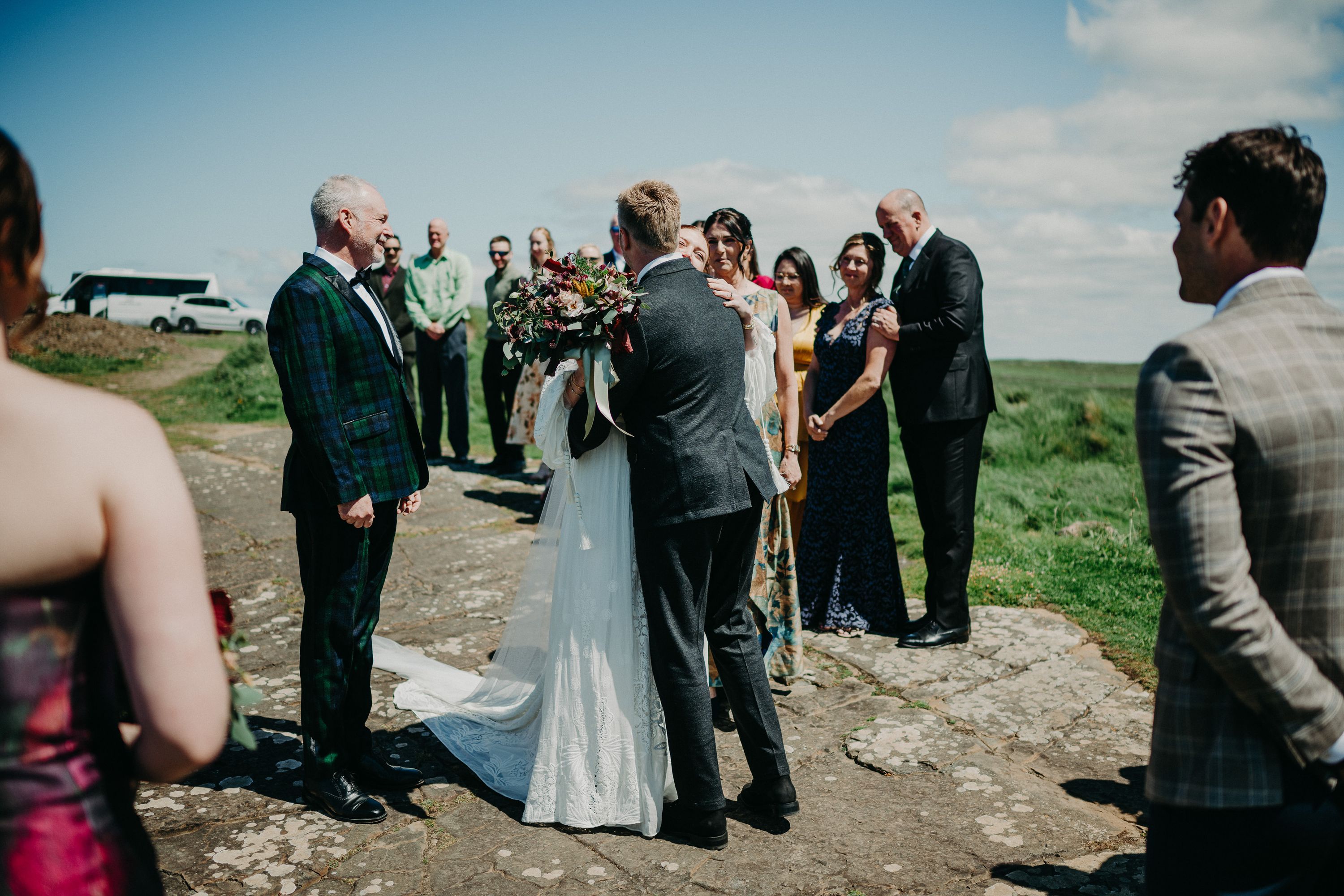 A groom seeing his bride for the first time while friends and family look on during their intimate wedding in Ireland