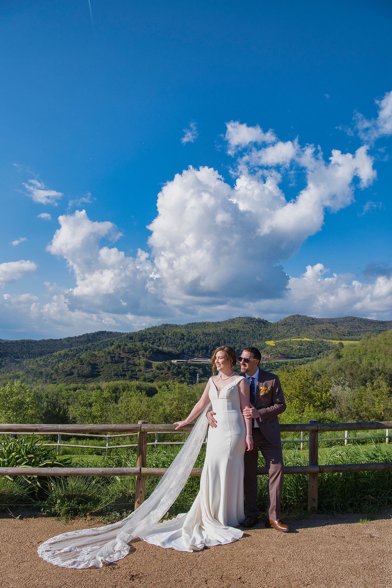 Bride and groom having a photoshoot for their destination wedding in Spain with a Barcelona countryside backdrop