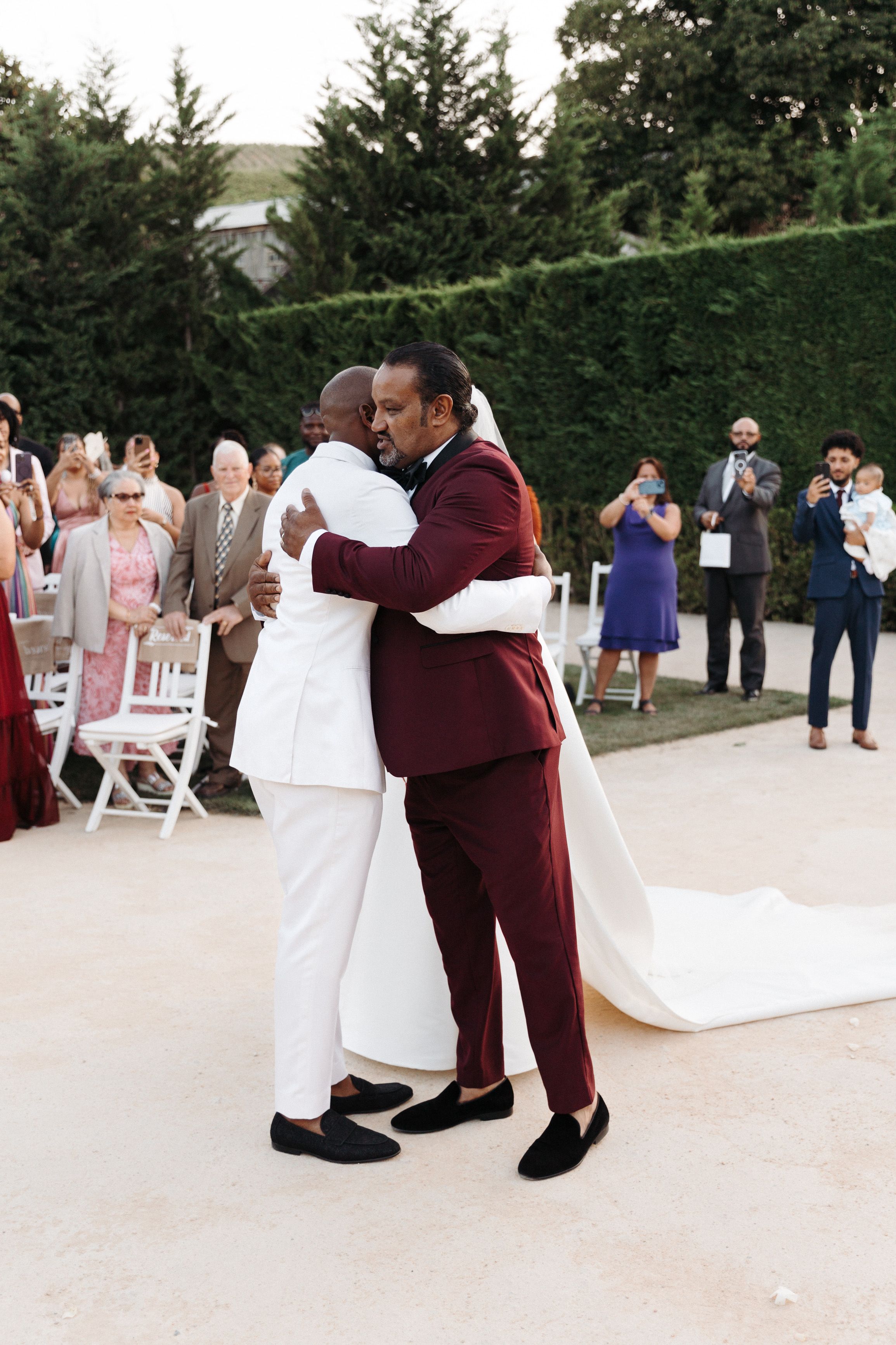 Emotional embrace between groom and father of the bride at a small wedding in Portugal celebration
