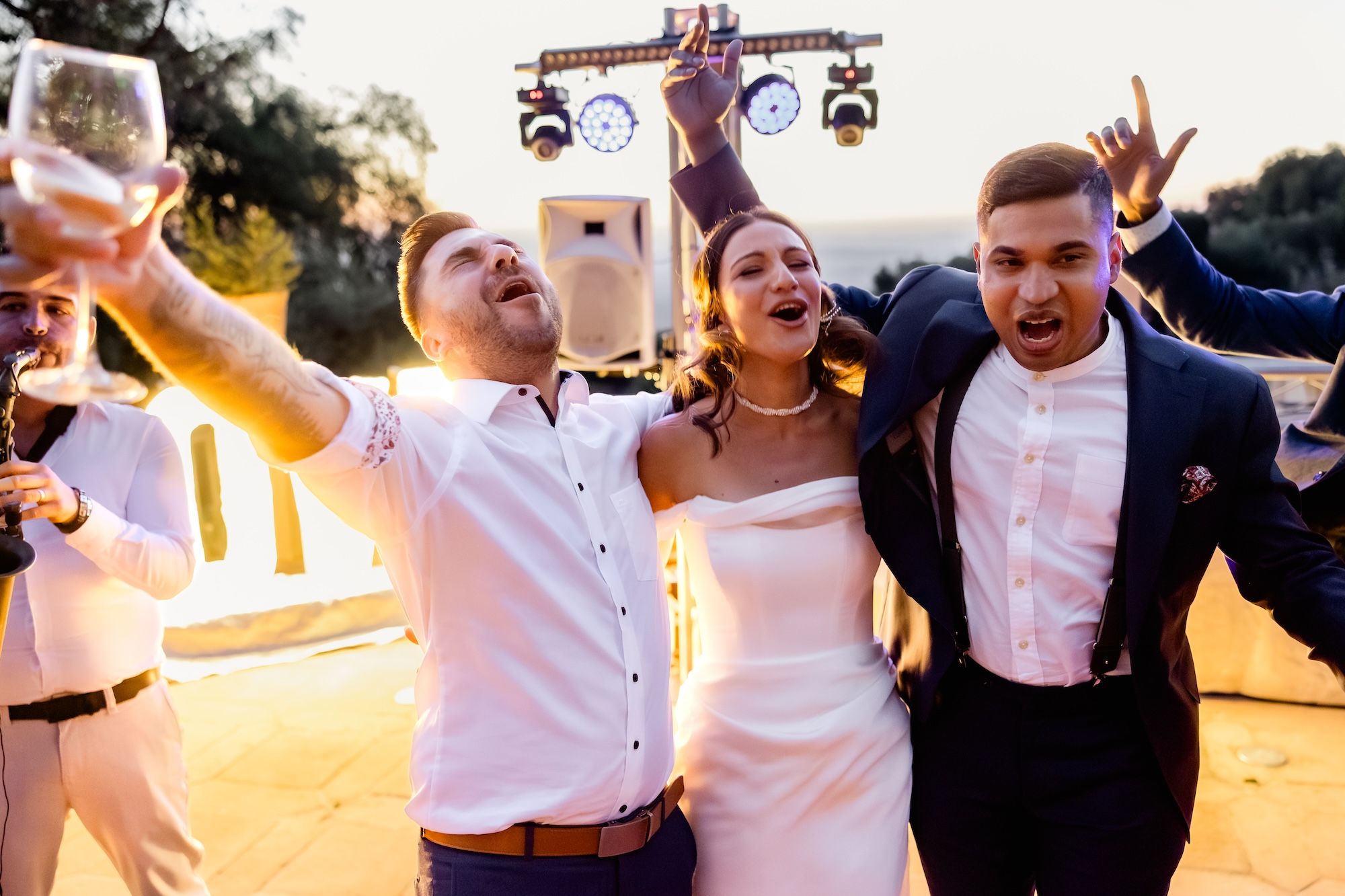 Bride joins guests as they sing and celebrate during their destination wedding in Spain