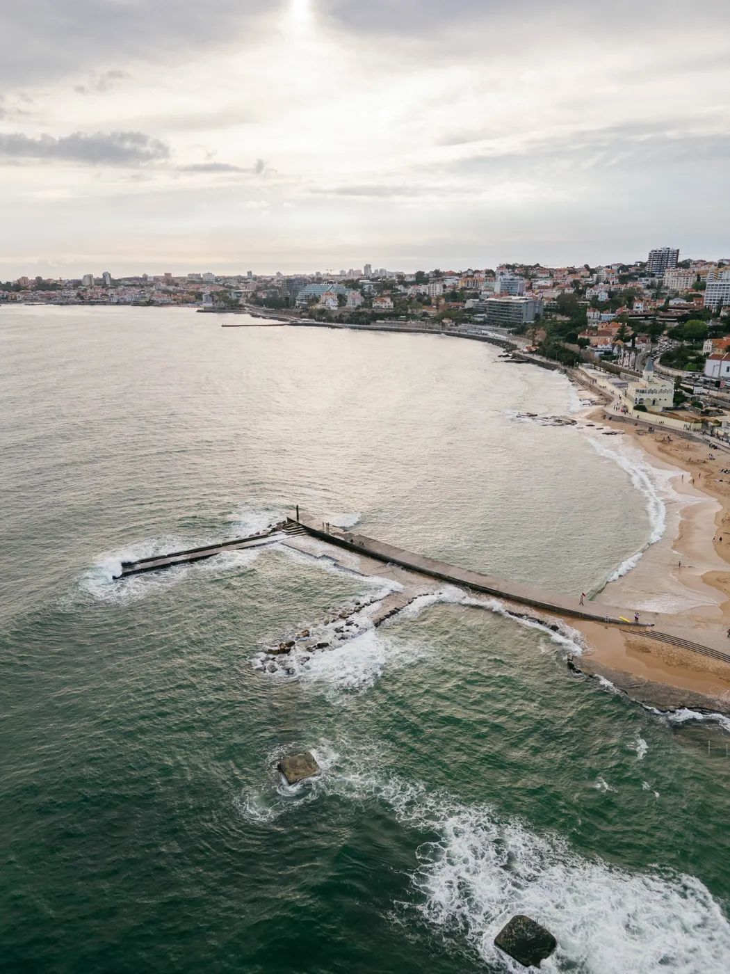 A picturesque sea and sandy beach with seaside buildings 