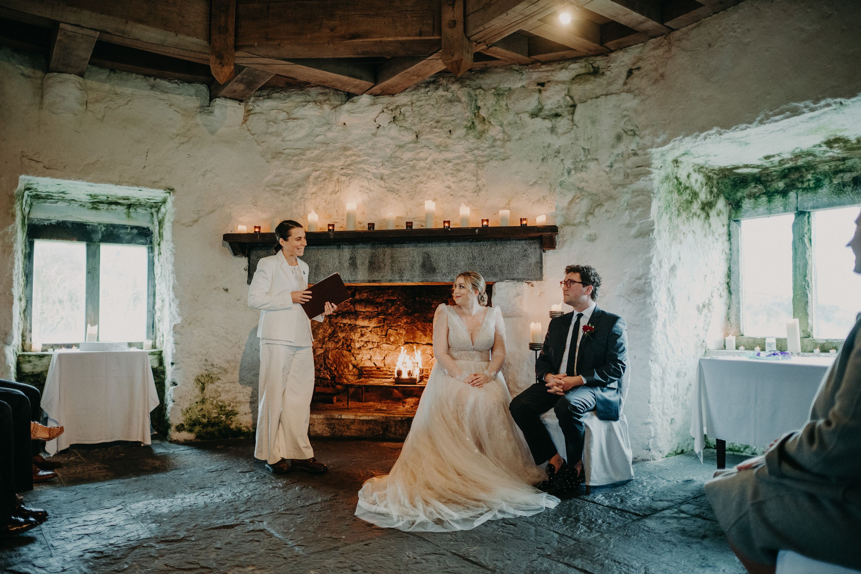 Couple seated by a roaring fireplace during an intimate wedding in Ireland ceremony