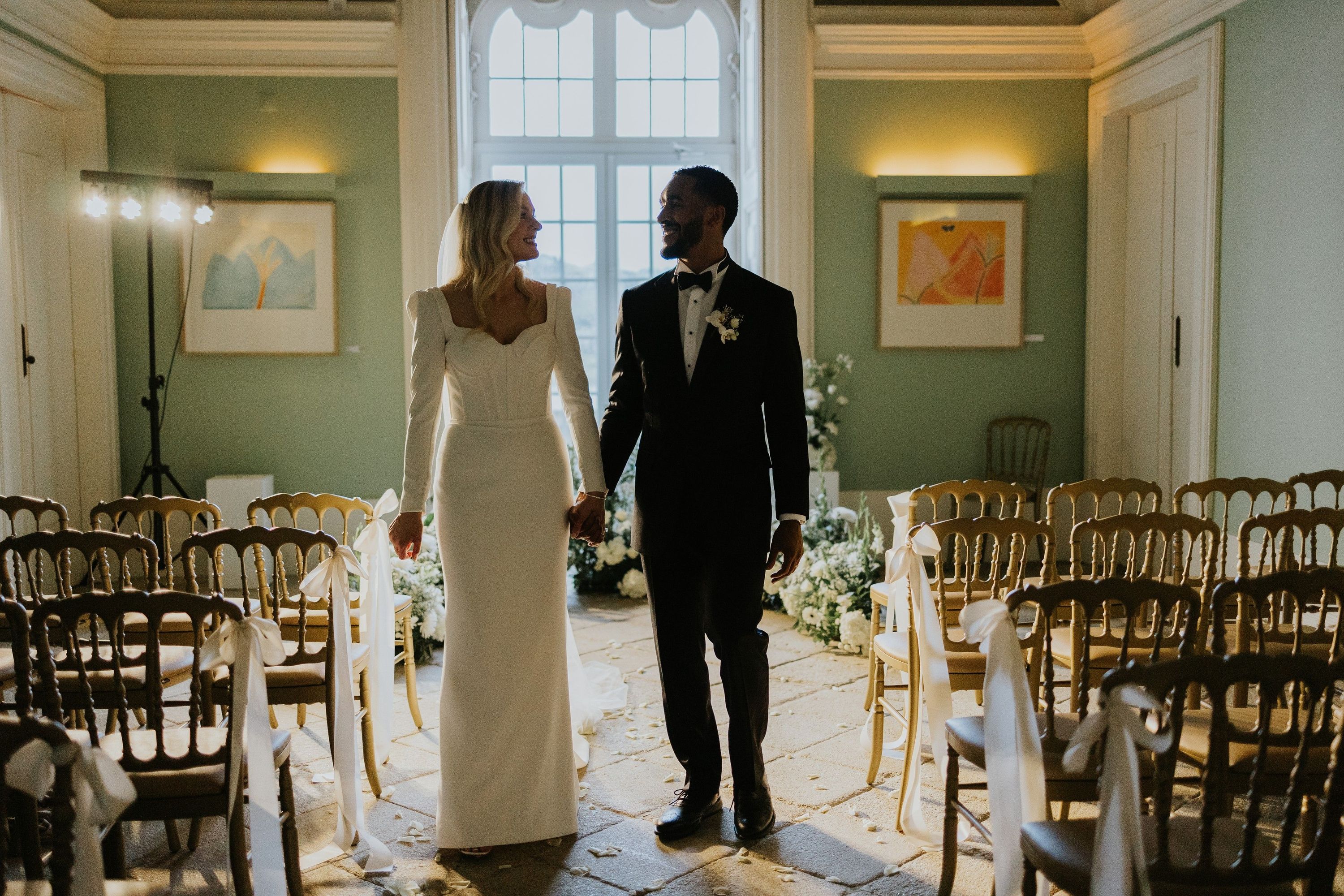 Bride and groom holding hand at their civil wedding ceremony in Portugal