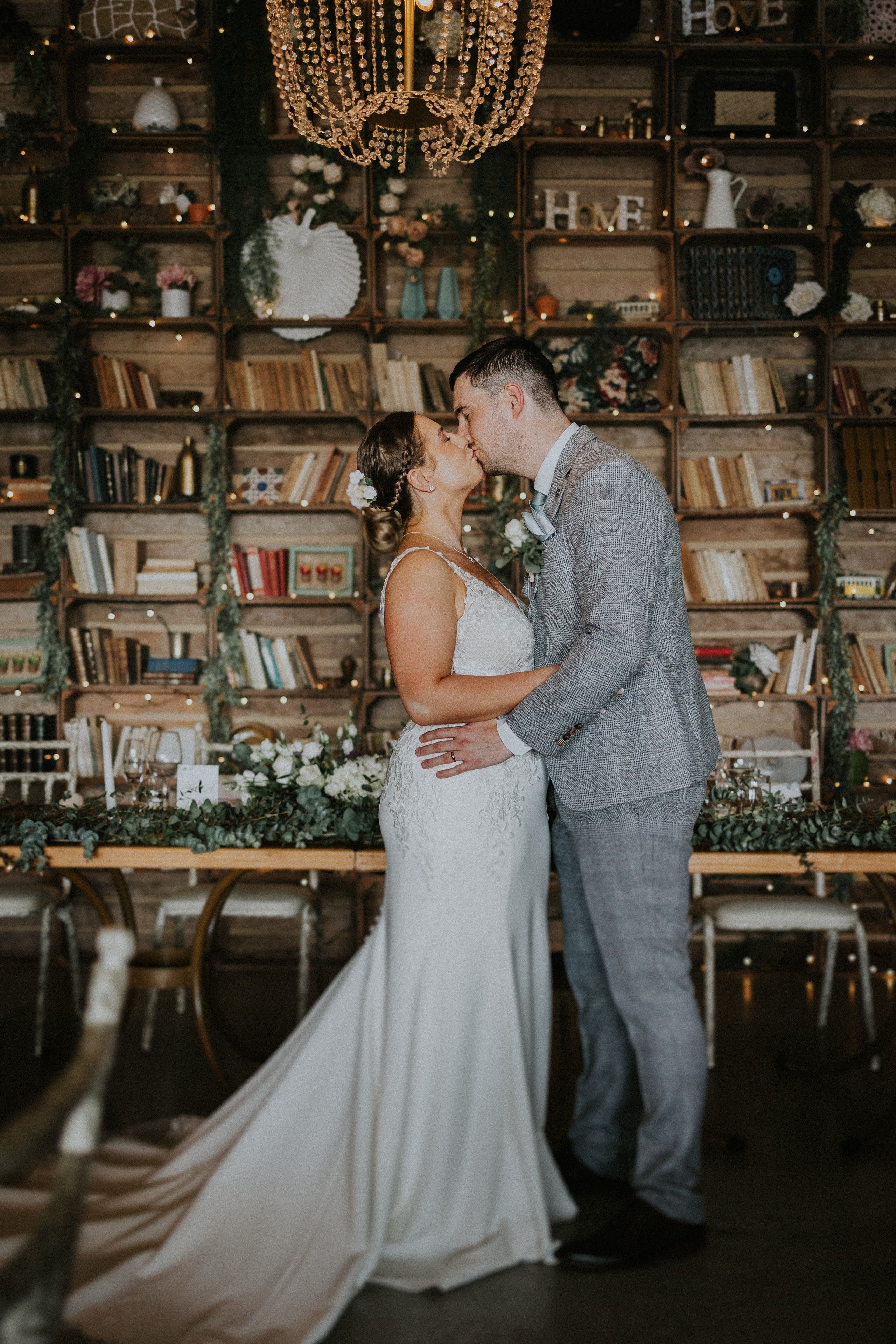 newlyweds kiss in a rustic event room during the reception of their intimate wedding in Portugal