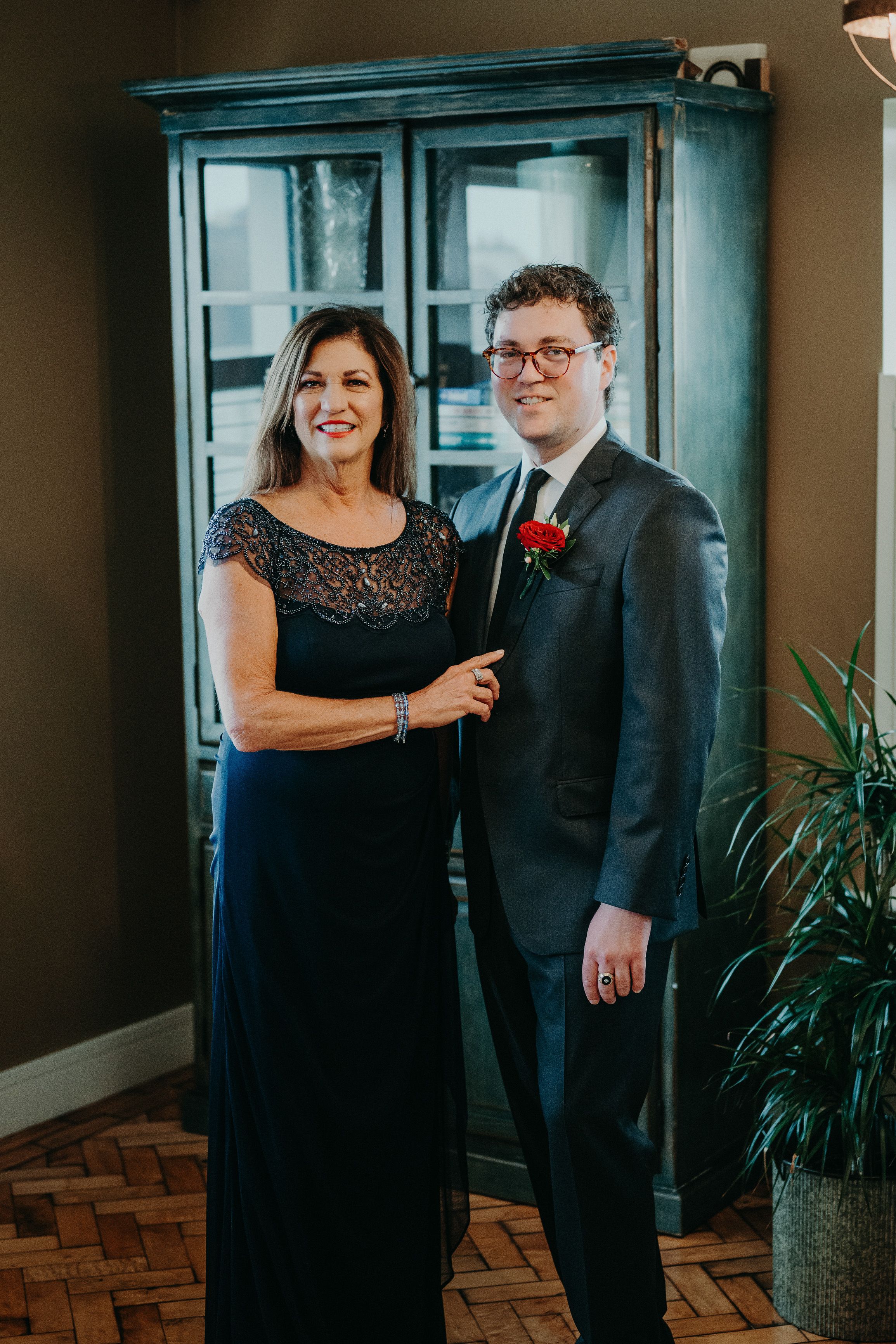 Groom posing with his mother during wedding preparations for a small wedding in Ireland