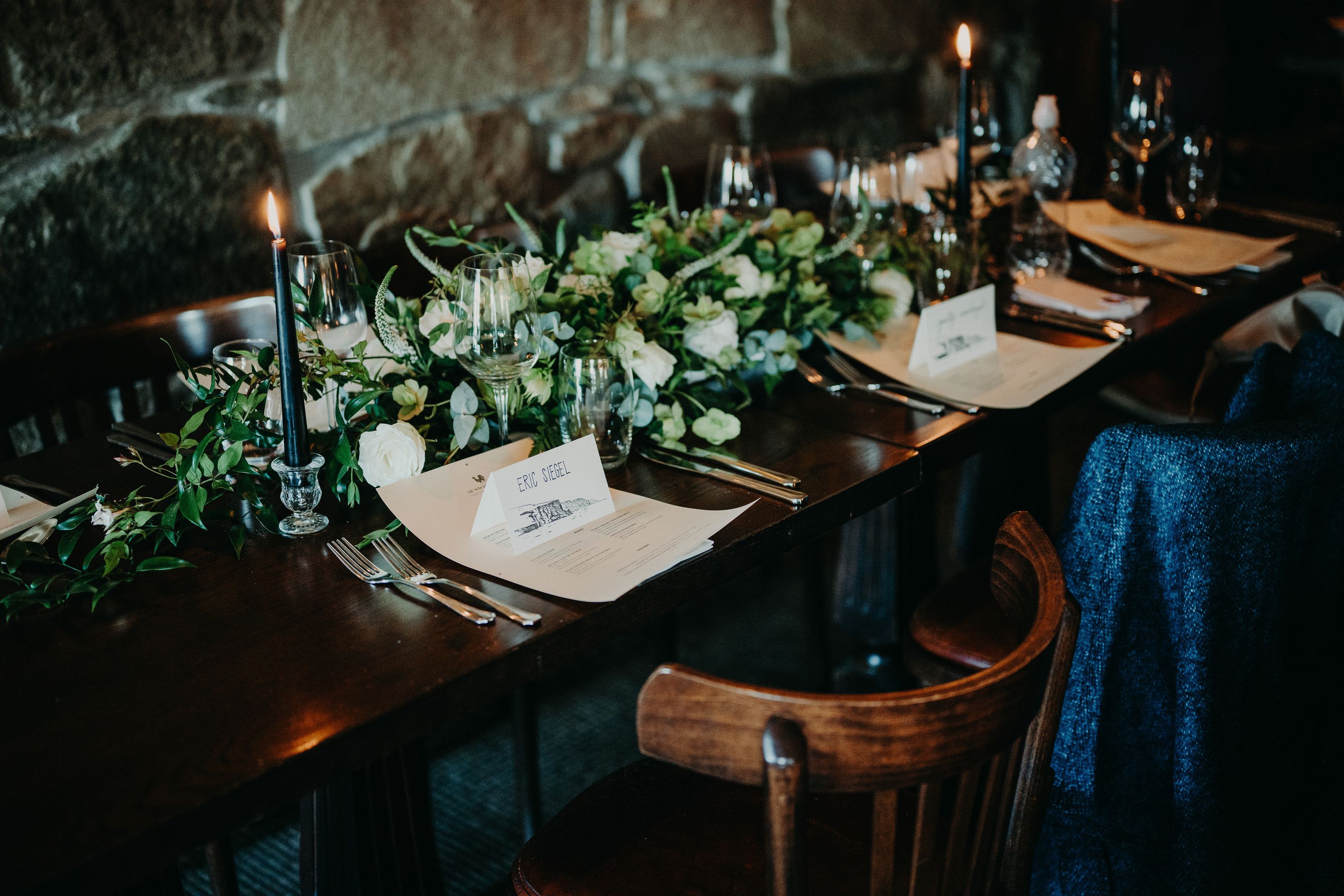 A table setup filled with leaves, candles, glasses for a reception party after a small wedding in Ireland