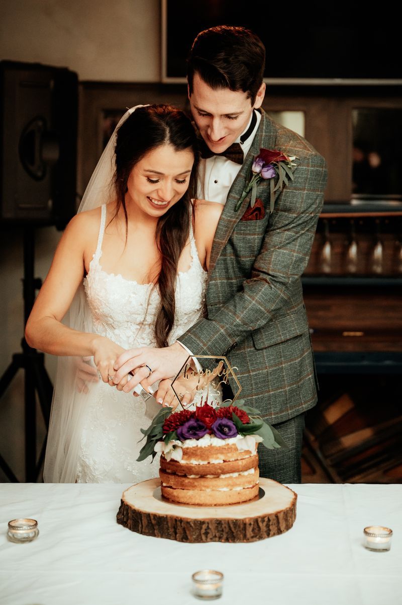 Bride and groom cutting their wedding cake during their destination wedding in Ireland