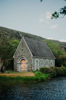 A lakeside chapel in Cork with a mountain backdrop where our couple had a small wedding in Ireland