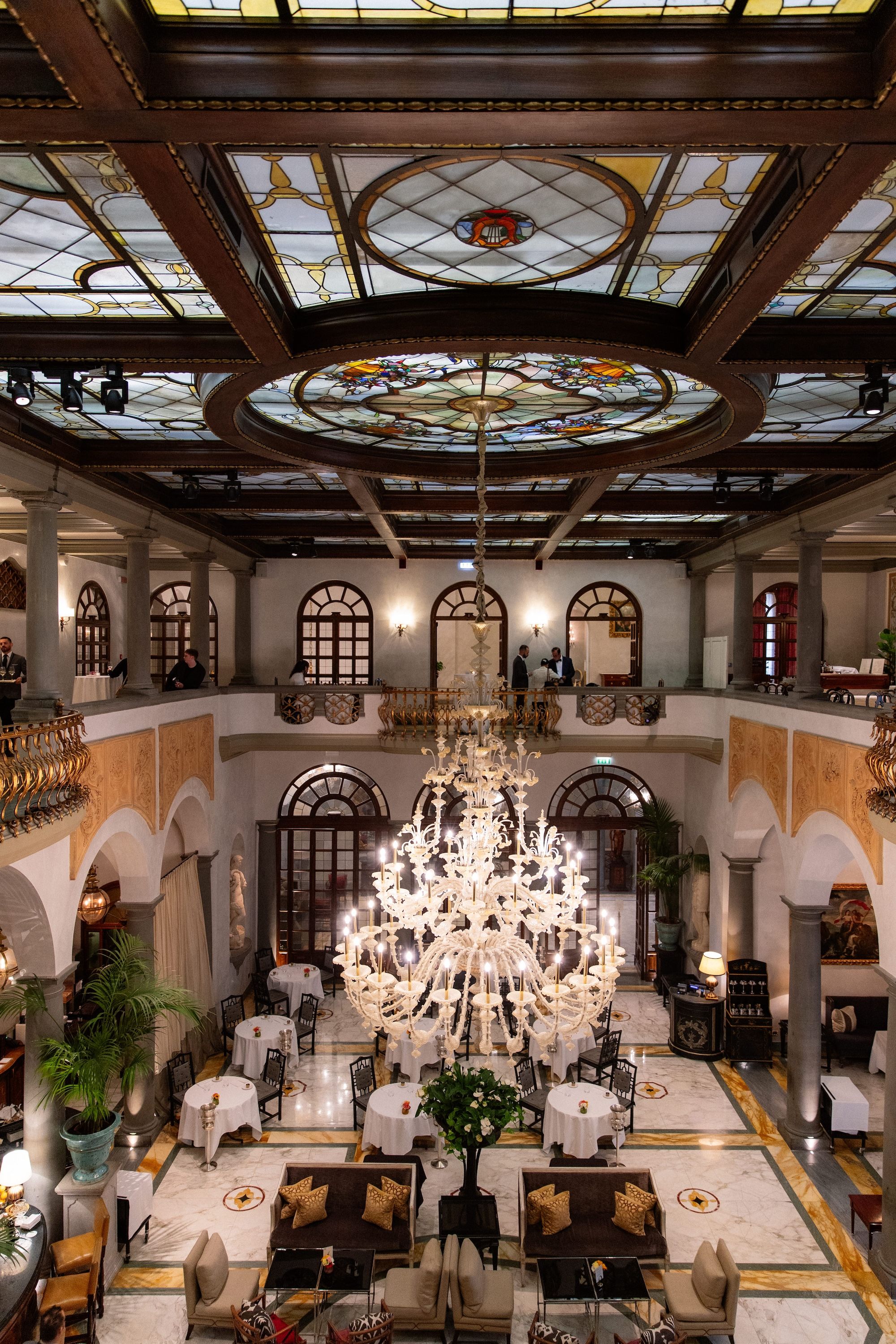 Indoor lobby of the hotel in Florence with intricate chandeliers for a vow renewal in Italy