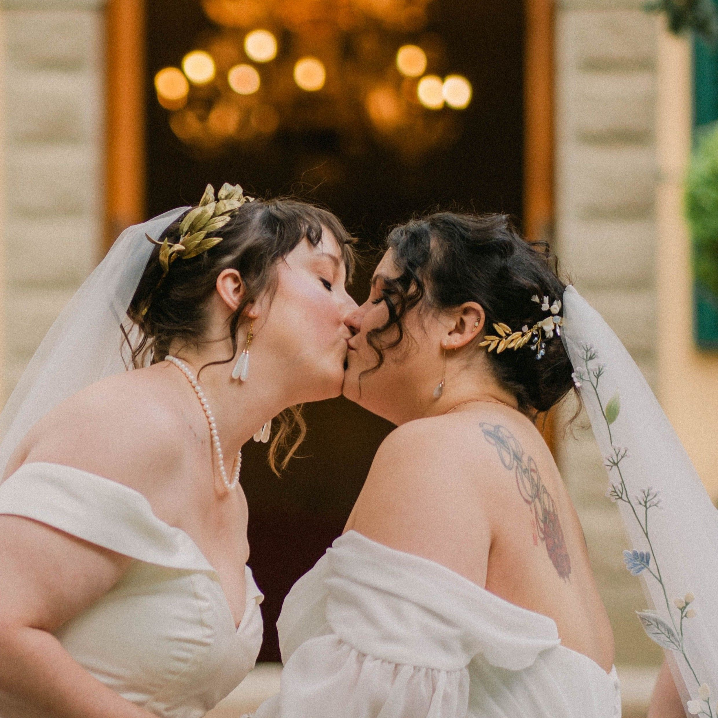 Two brides kissing at their wedding ceremony in Italy