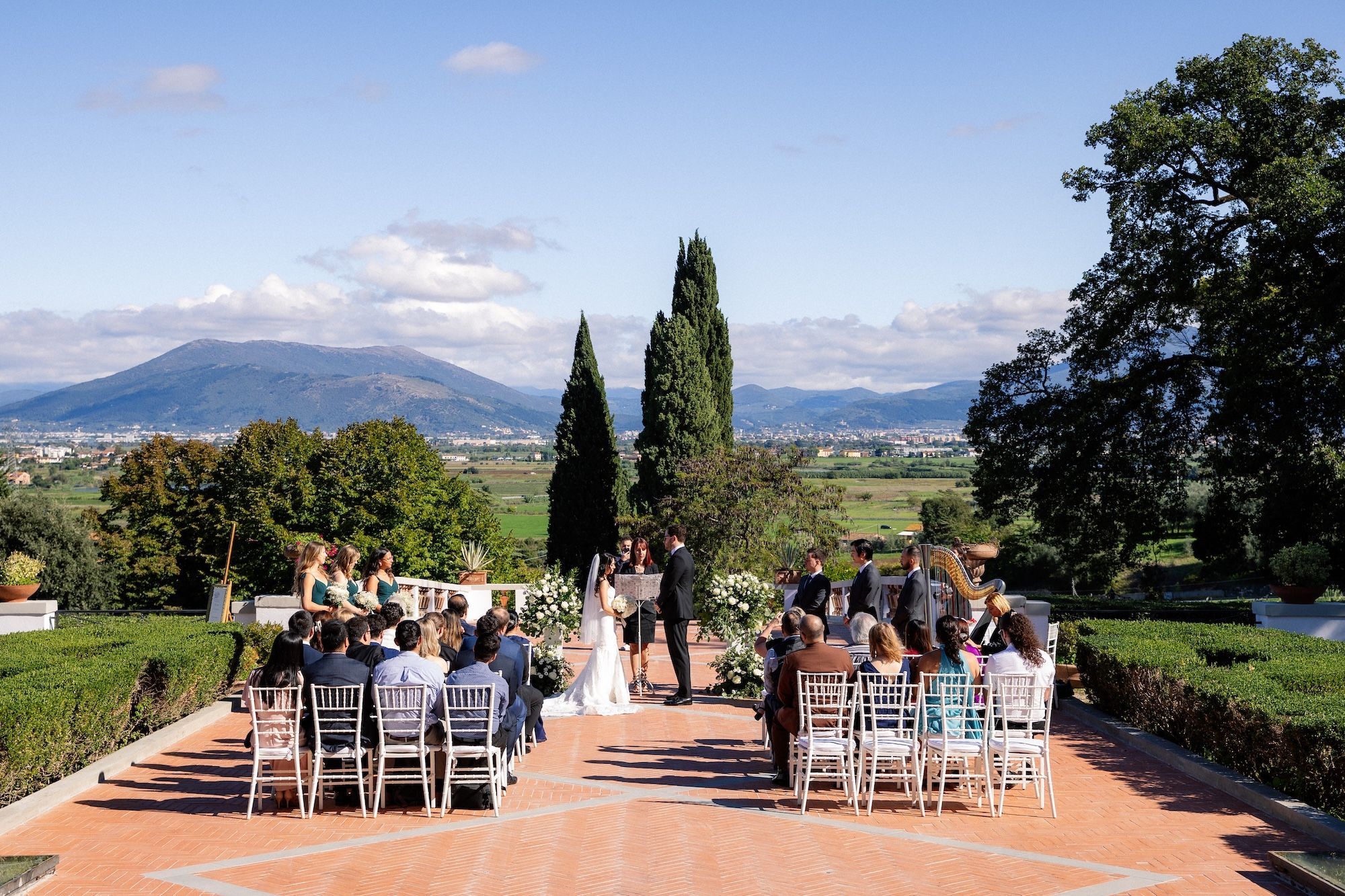 Bride and groom are having an outdoor ceremony as they renew vows in Italy
