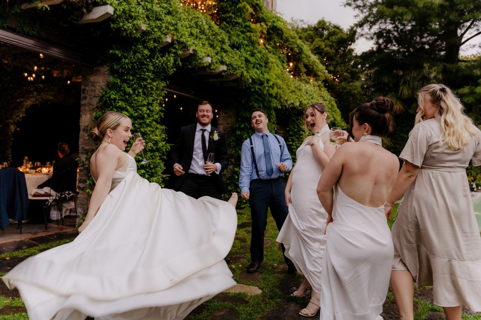 Bride dancing with her guests in an outdoor wedding reception of their intimate wedding in Italy