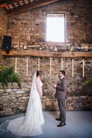 Groom recites vows in front of his bride in a medieval event room during their destination wedding in Spain