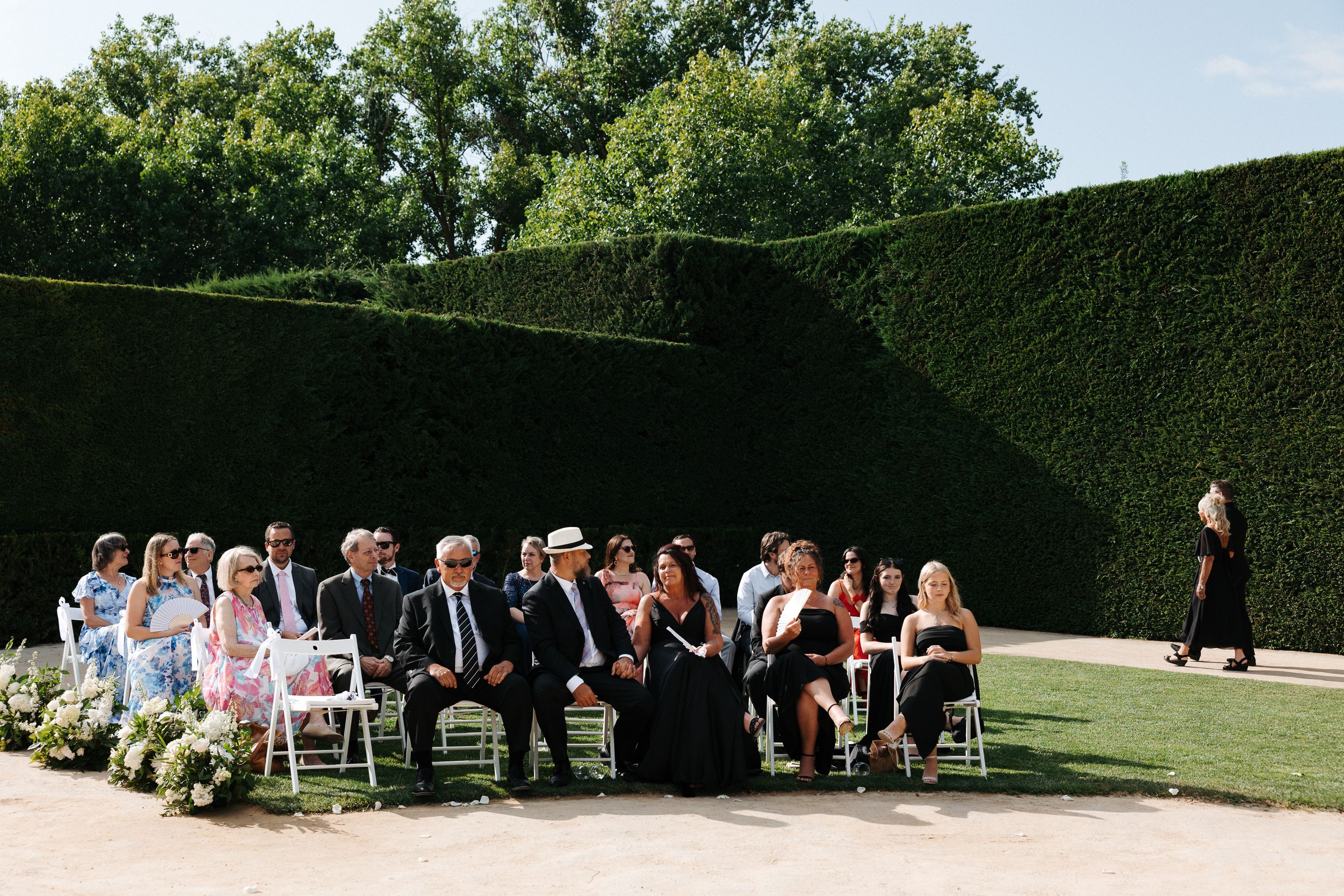 Wedding guests seated in a formal garden setting at an intimate wedding in Portugal celebration