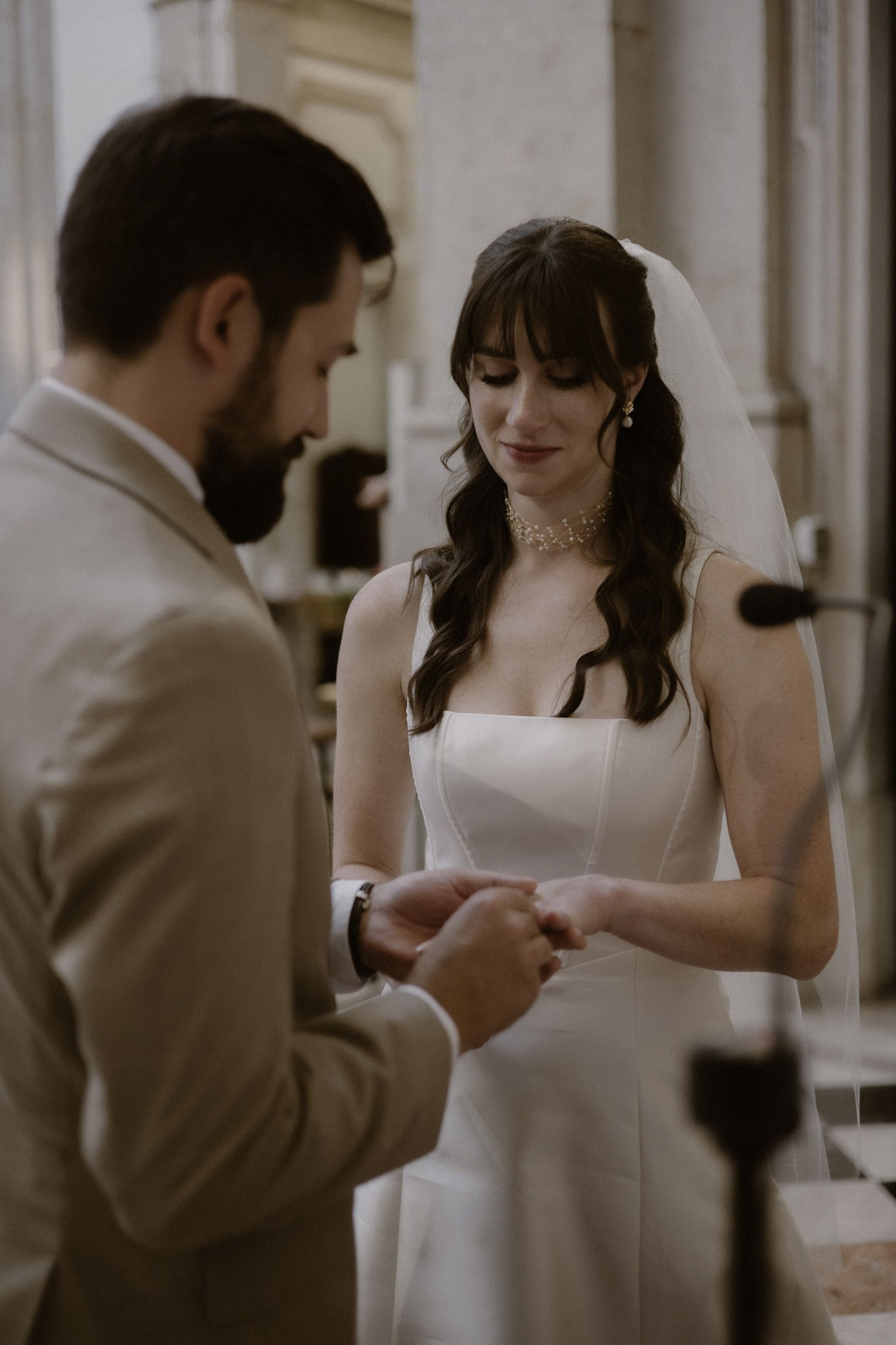 Close-up of a wedding ring exchange inside a church during a small wedding in Portugal celebration