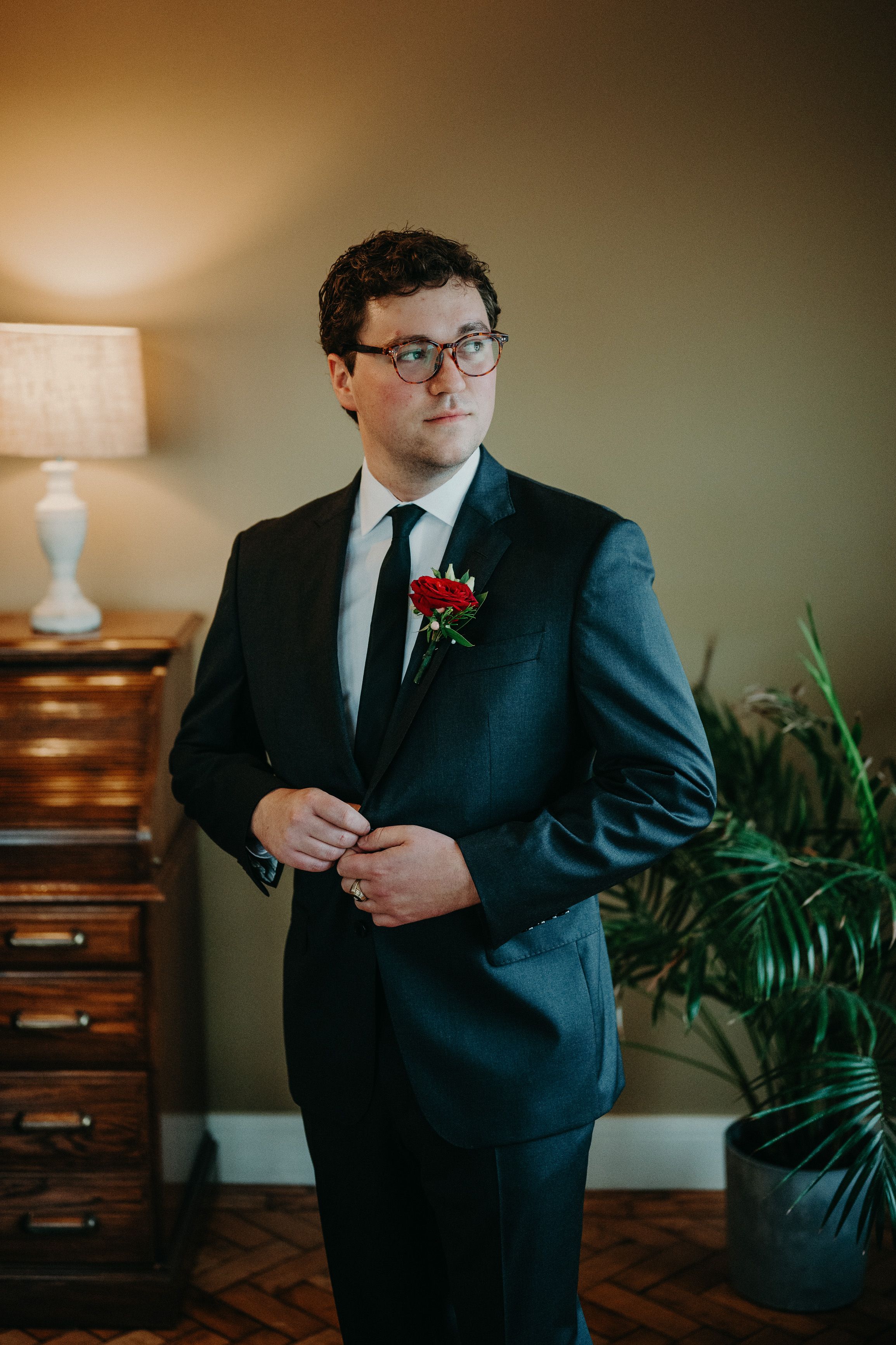 Groom portrait in a tailored suit during preparations for an intimate wedding in Ireland