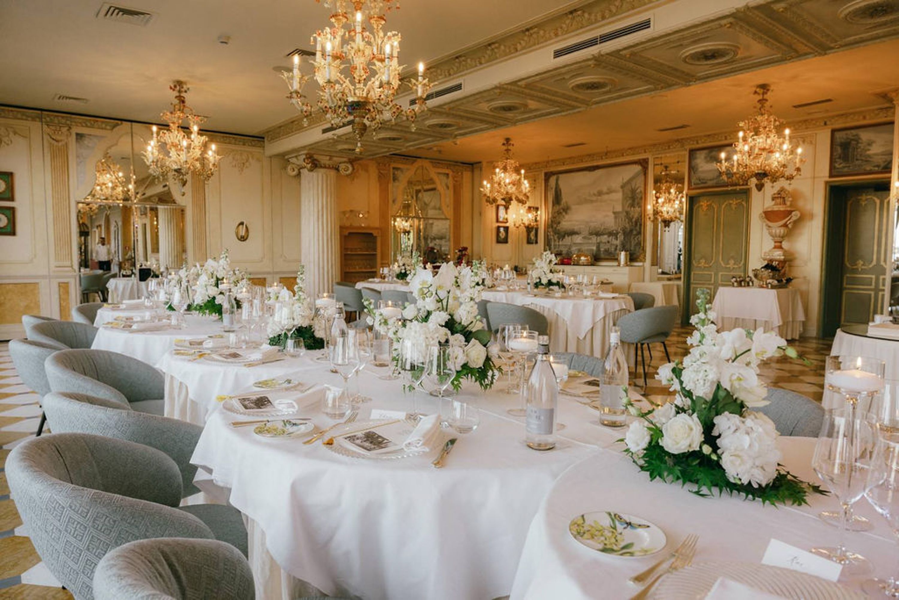 Elegant reception room with white floral tablescapes for a small wedding in Italy
