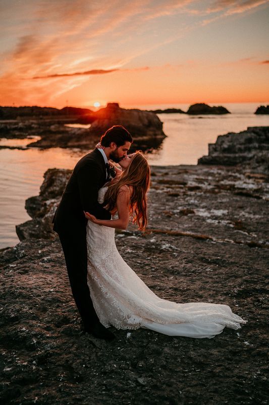 Bride and groom kissing at sunset for their elopement in Northern Ireland