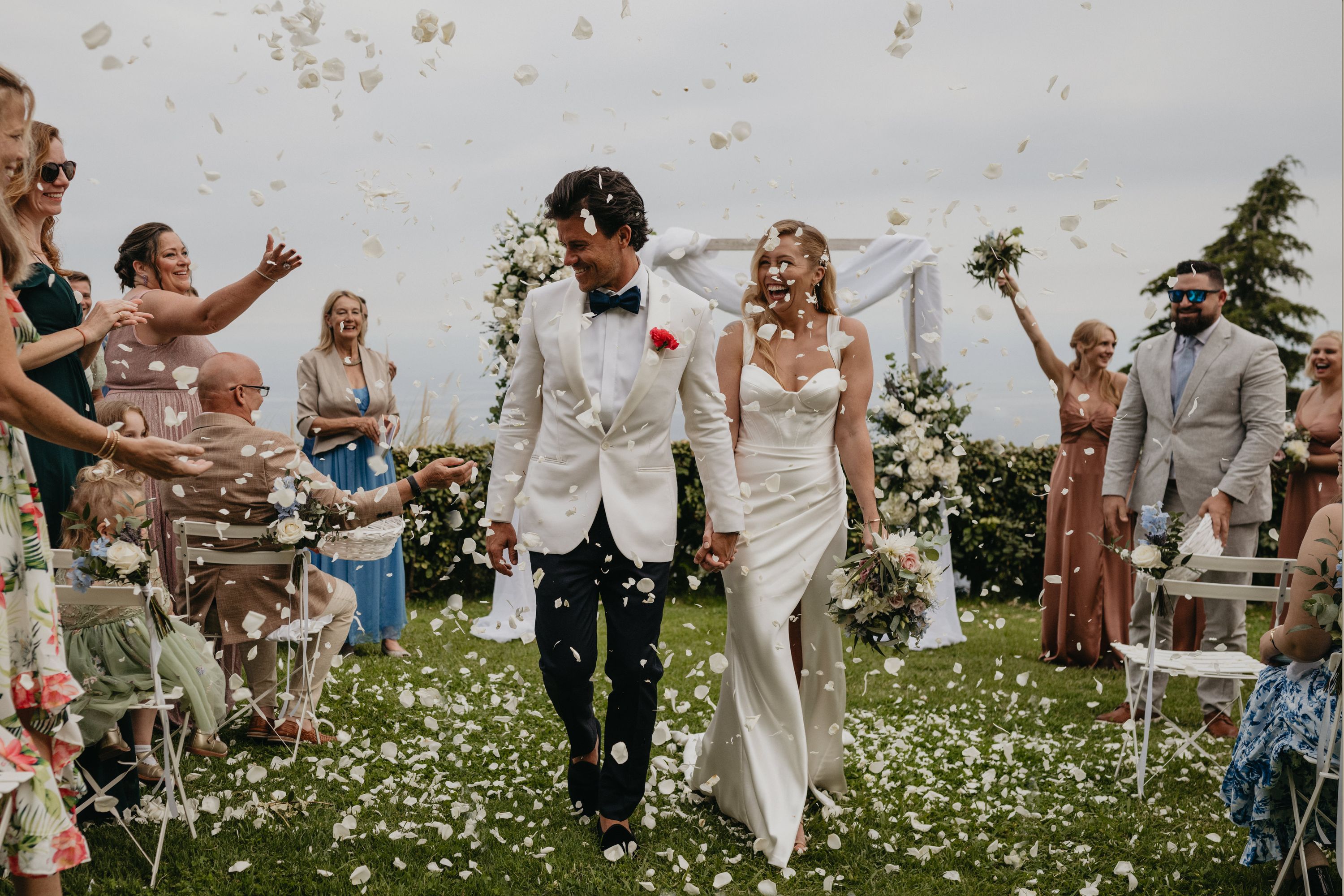 a couple having flower petals thrown at them
