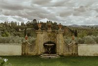 A medieval fountain of a Renaissance hotel and resort in Florence surrounded by the Tuscan greenery