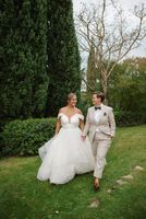 Newlyweds walking along the large Tuscan estate where they had a micro wedding in Italy