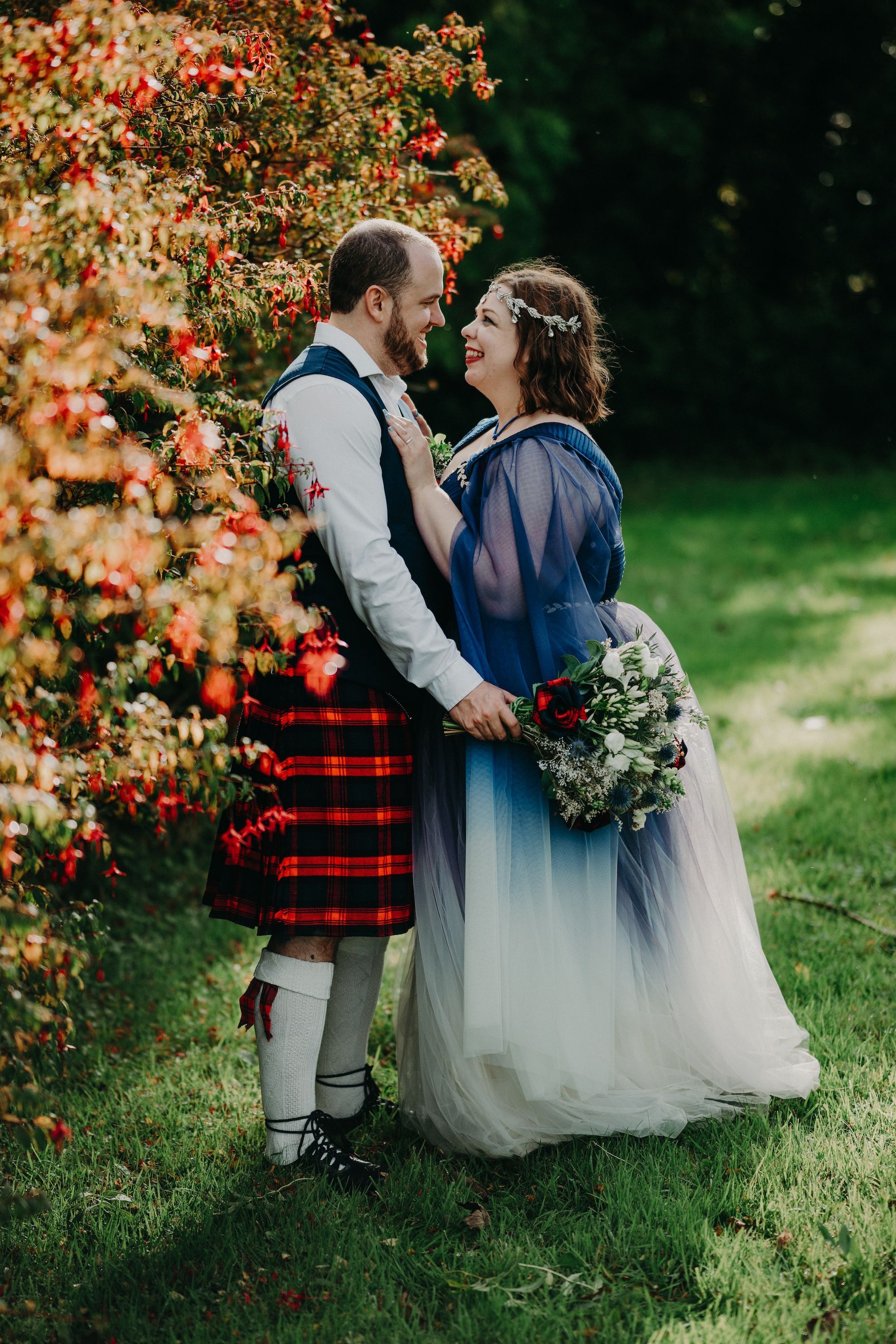 Bride and groom does a romantic photoshoot with the autumn bushes behind them when they eloped in Ireland