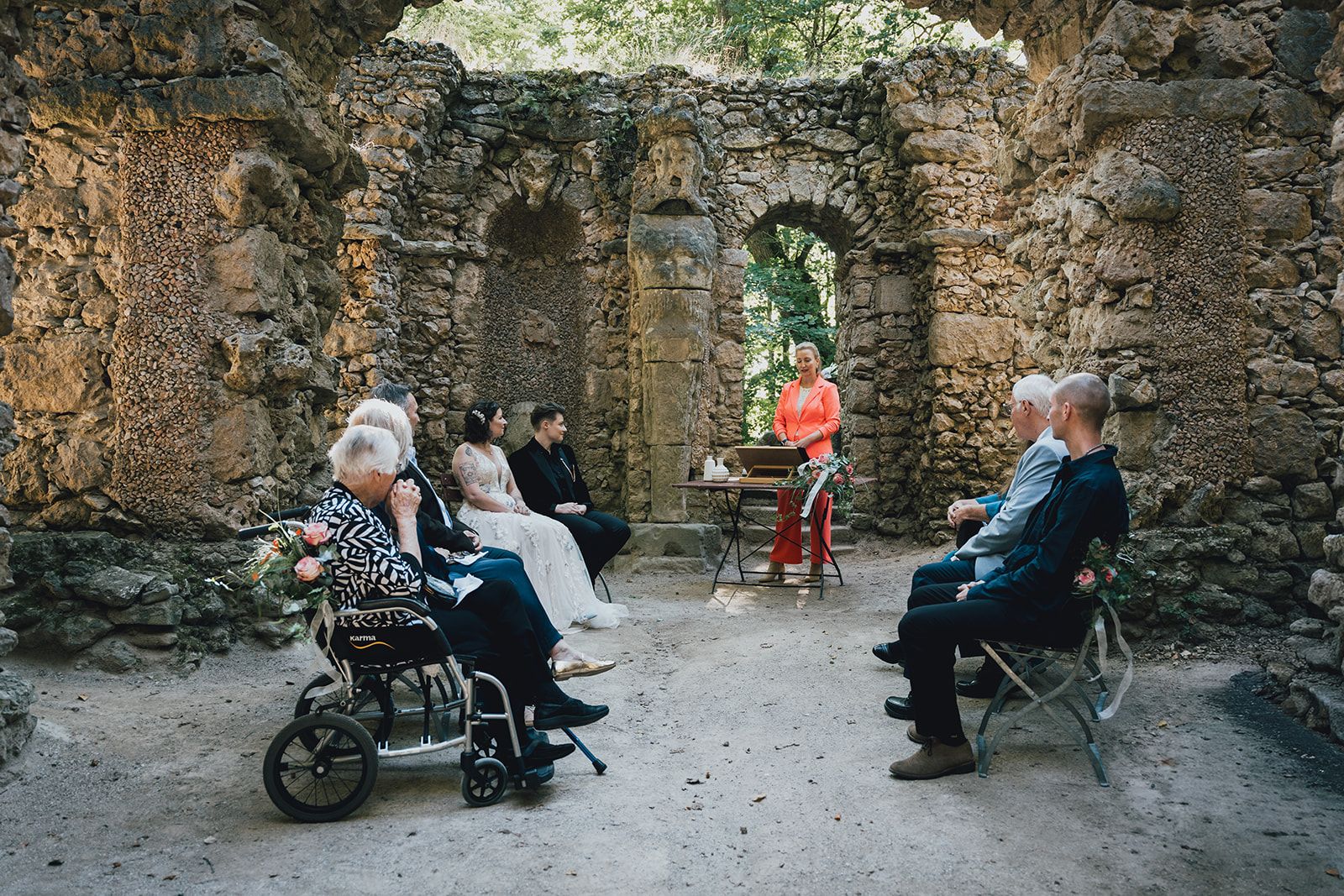 A bride, groom, and their intimate party witnessing a small wedding set in a rock garden in Germany