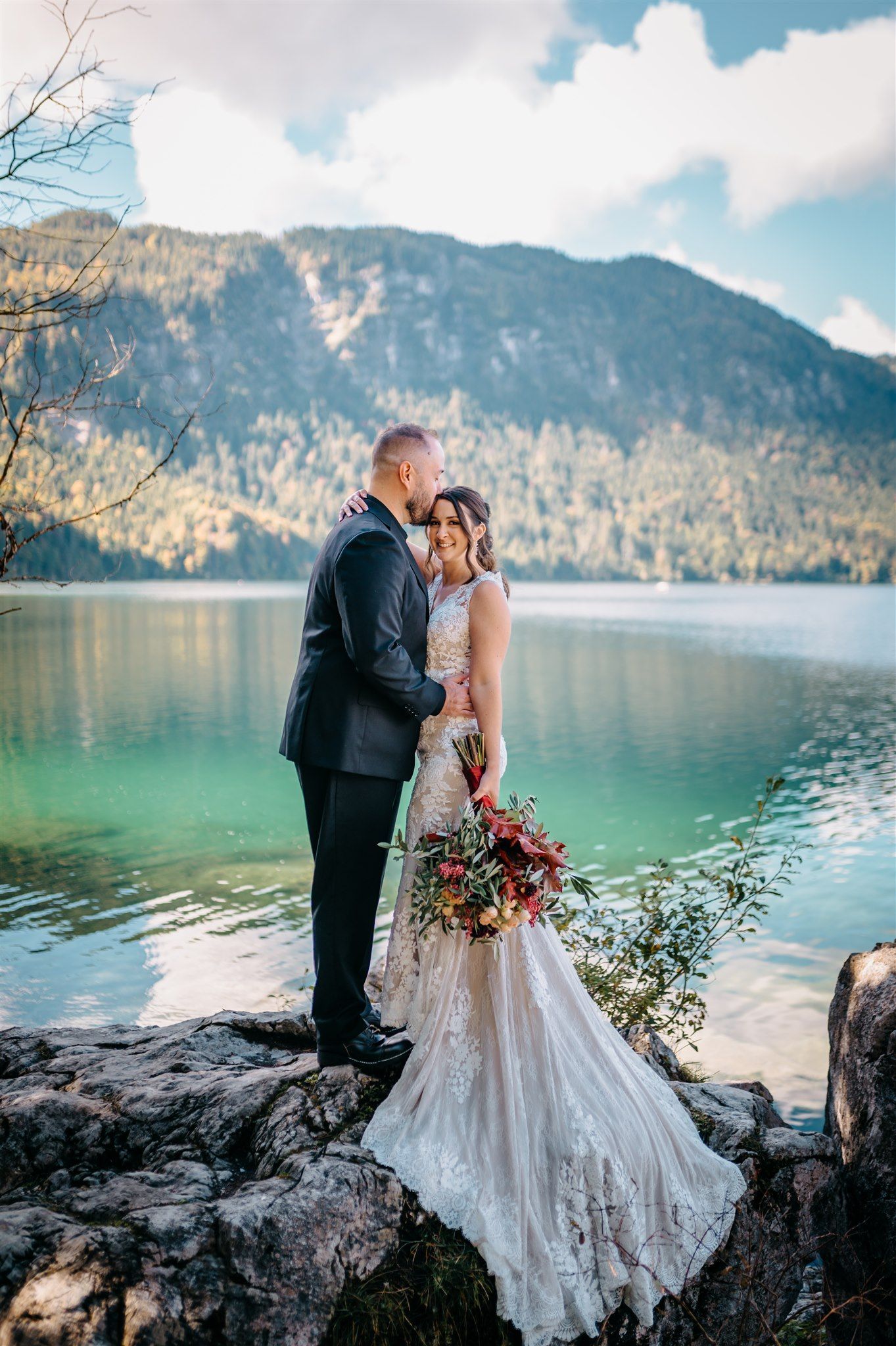 Bride and groom posing on a lake at a destination elopent in Europe