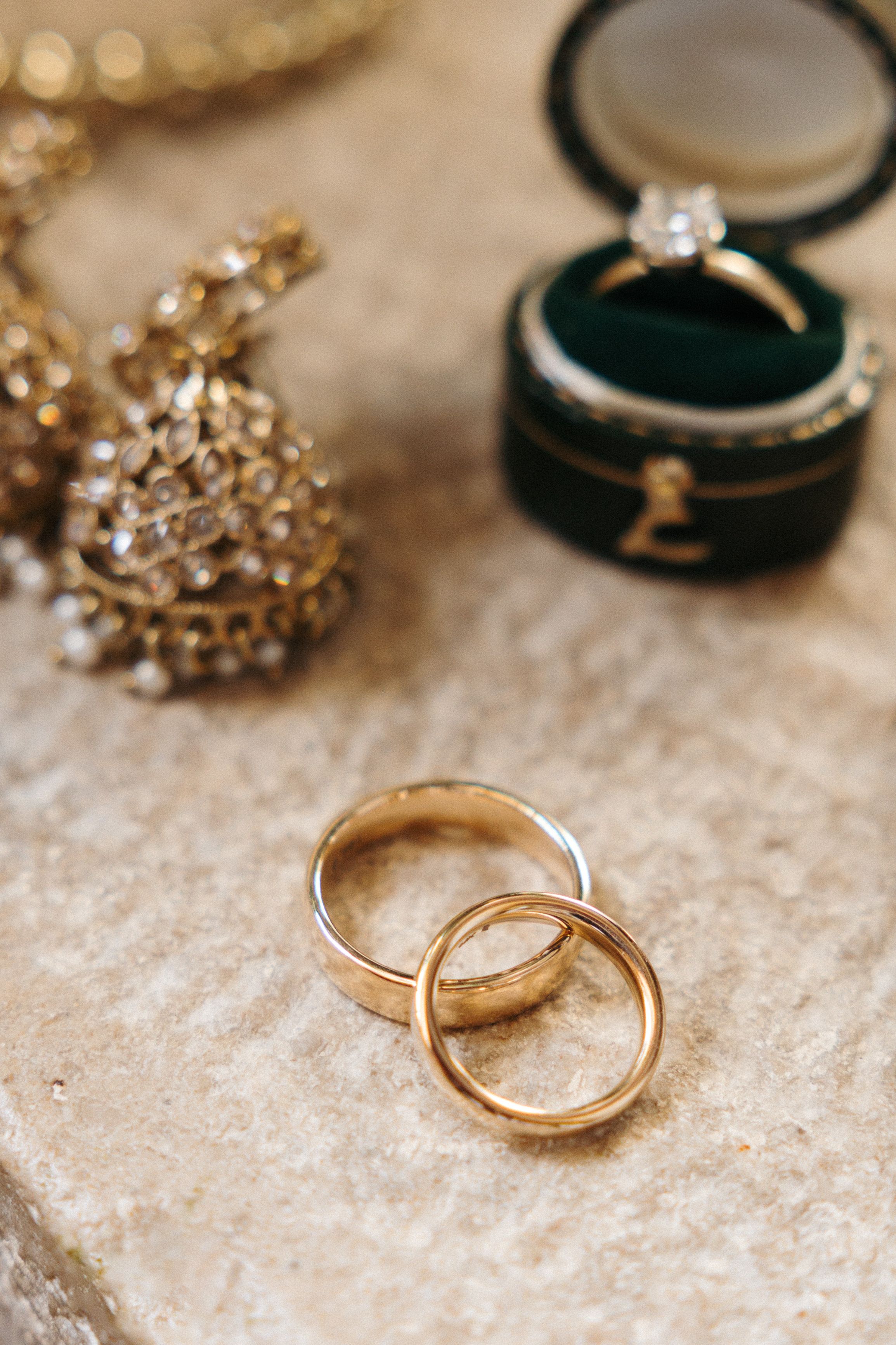 Gold wedding bands and engagement ring displayed during preparations for a small wedding in Italy