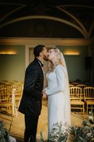 Bride and groom kissing after their indoor ceremony in a palace hotel during their small wedding in Portugal