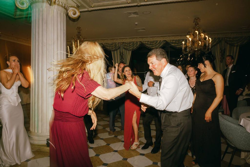 Wedding guests celebrating on the dance floor at an intimate wedding in Italy venue