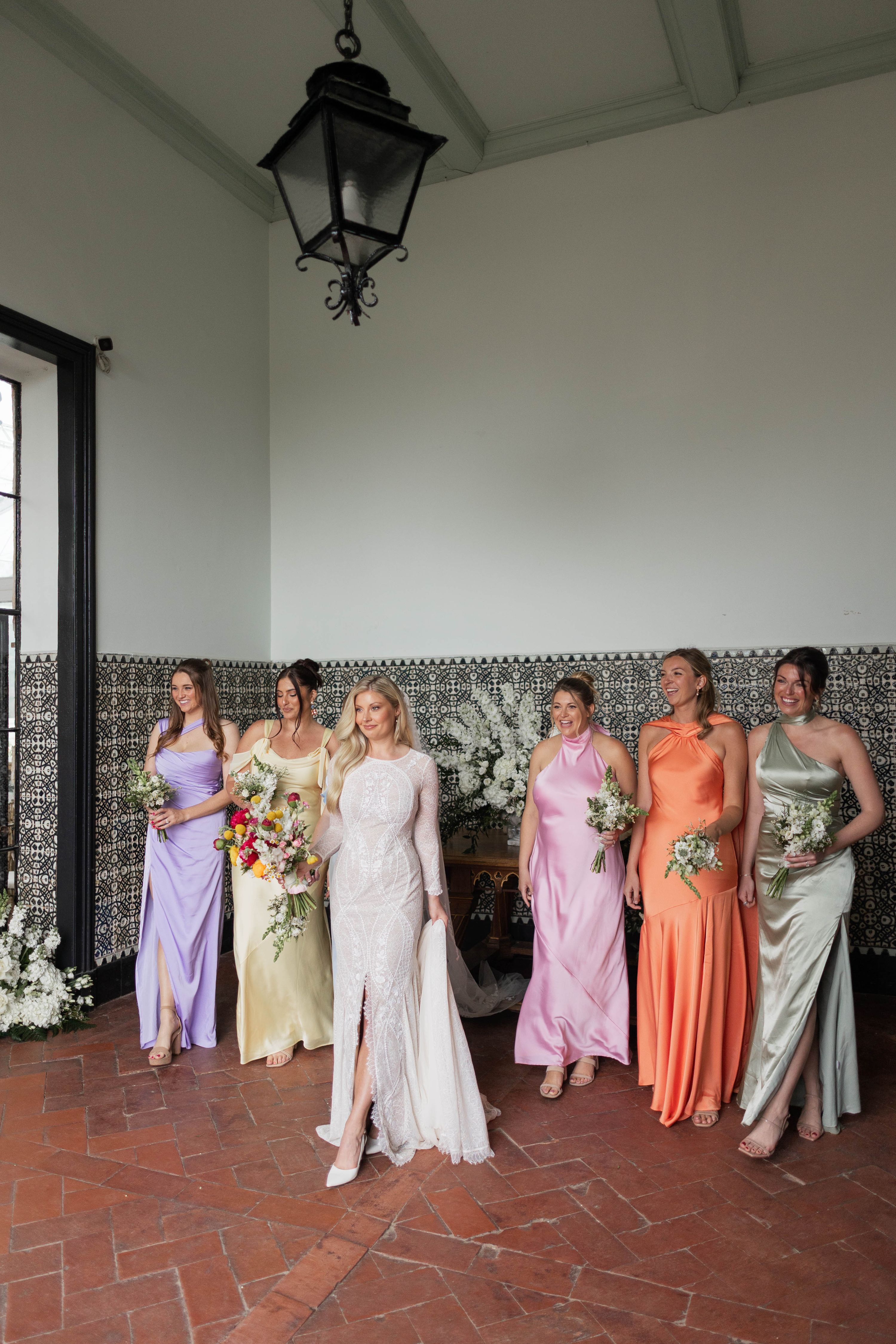 Bride in her wedding dress with her bridesmaids during the photoshoot of her destination wedding in Portugal