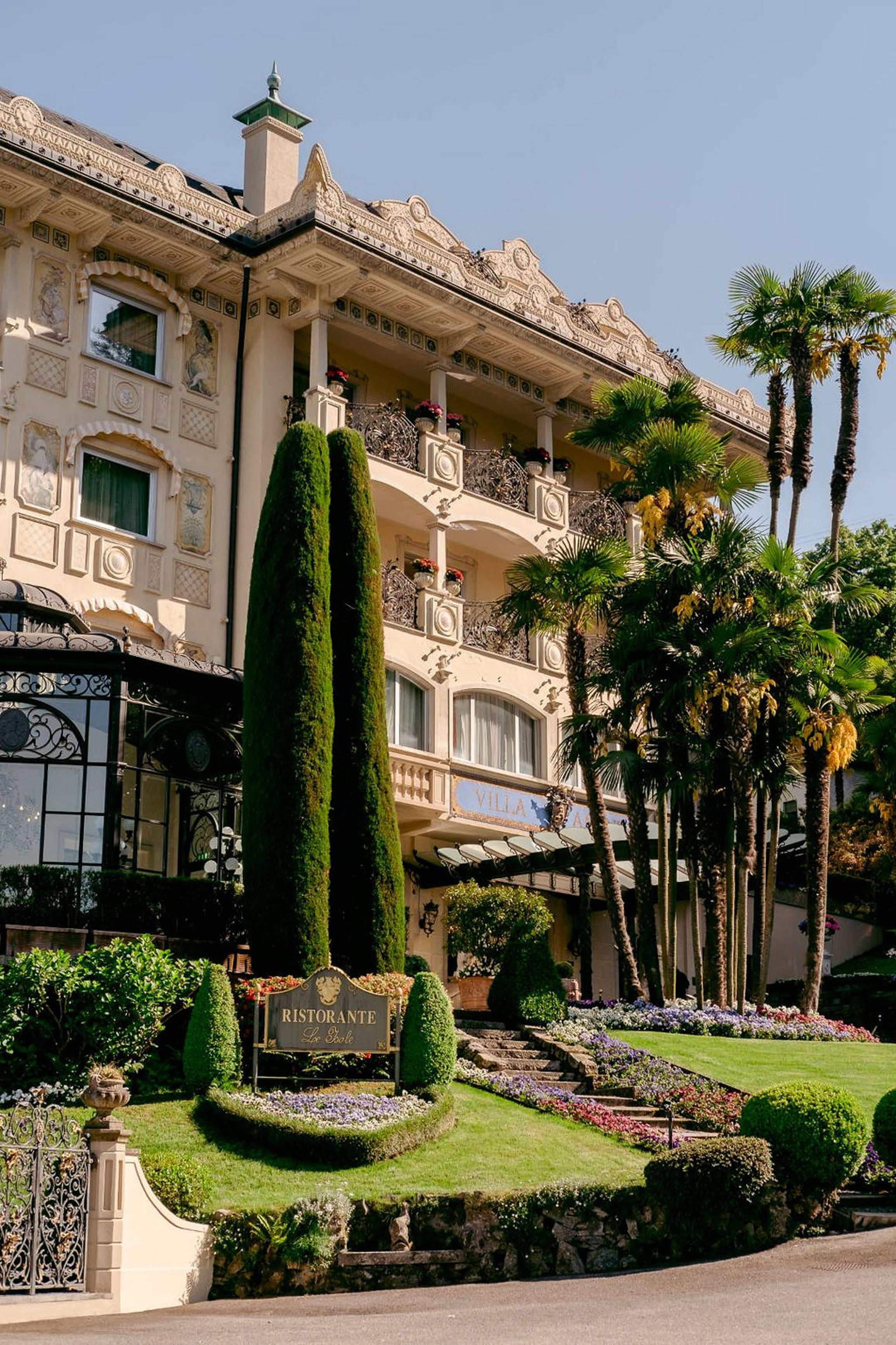 Luxury lakeside hotel surrounded by gardens and palms, a stunning venue for an intimate wedding in Italy