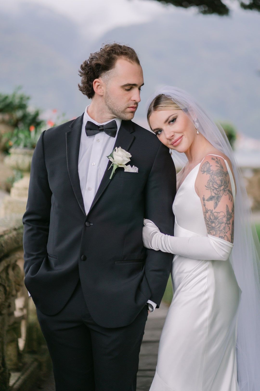 A bride and groom having their portrait taken during their intimate wedding in Italy