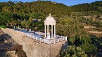 Clifftop venue in Mallorca for a destination wedding in Spain with forested hills in the background