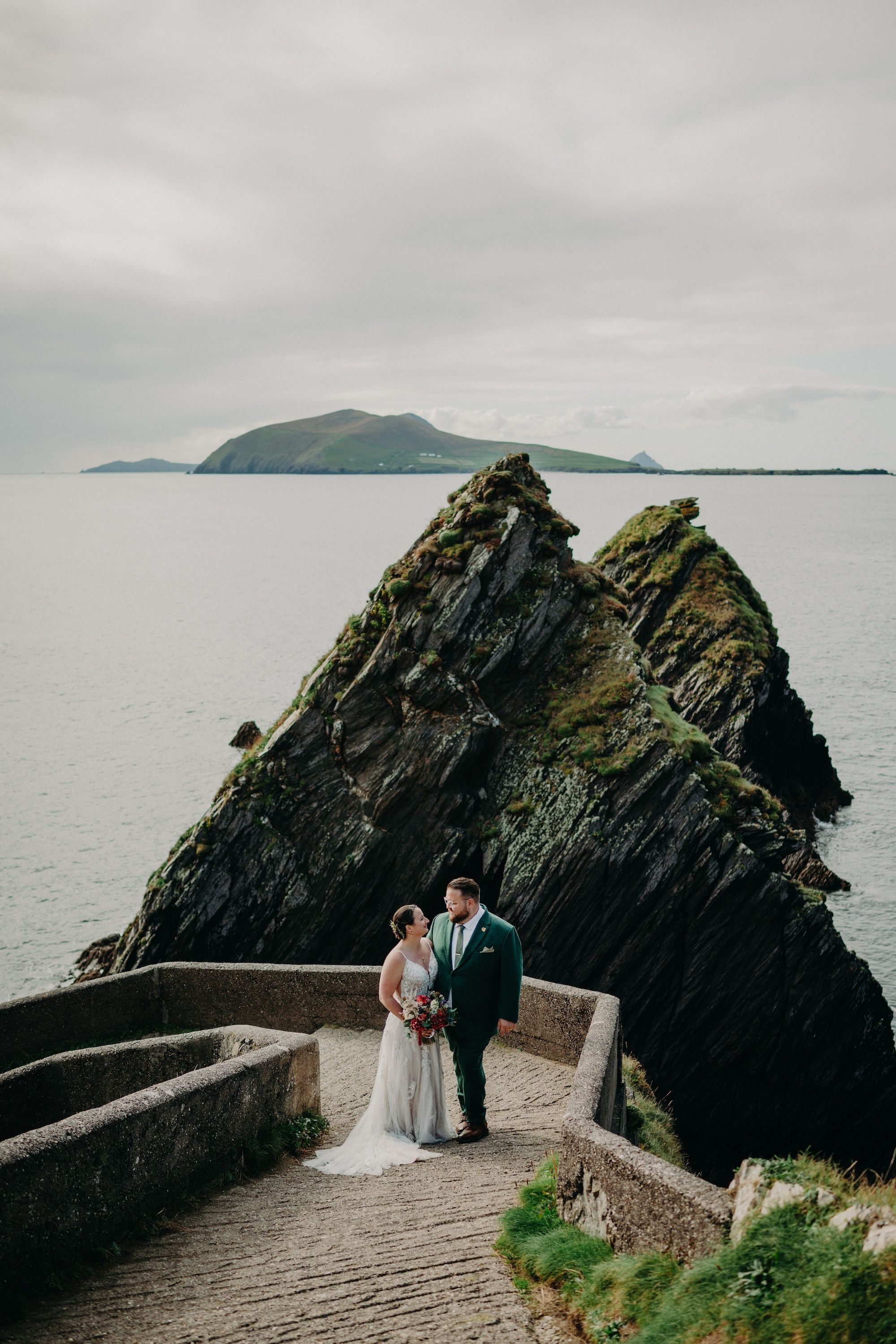 Newlyweds looking at each other during their Slea Head photoshoot when they eloped in Ireland