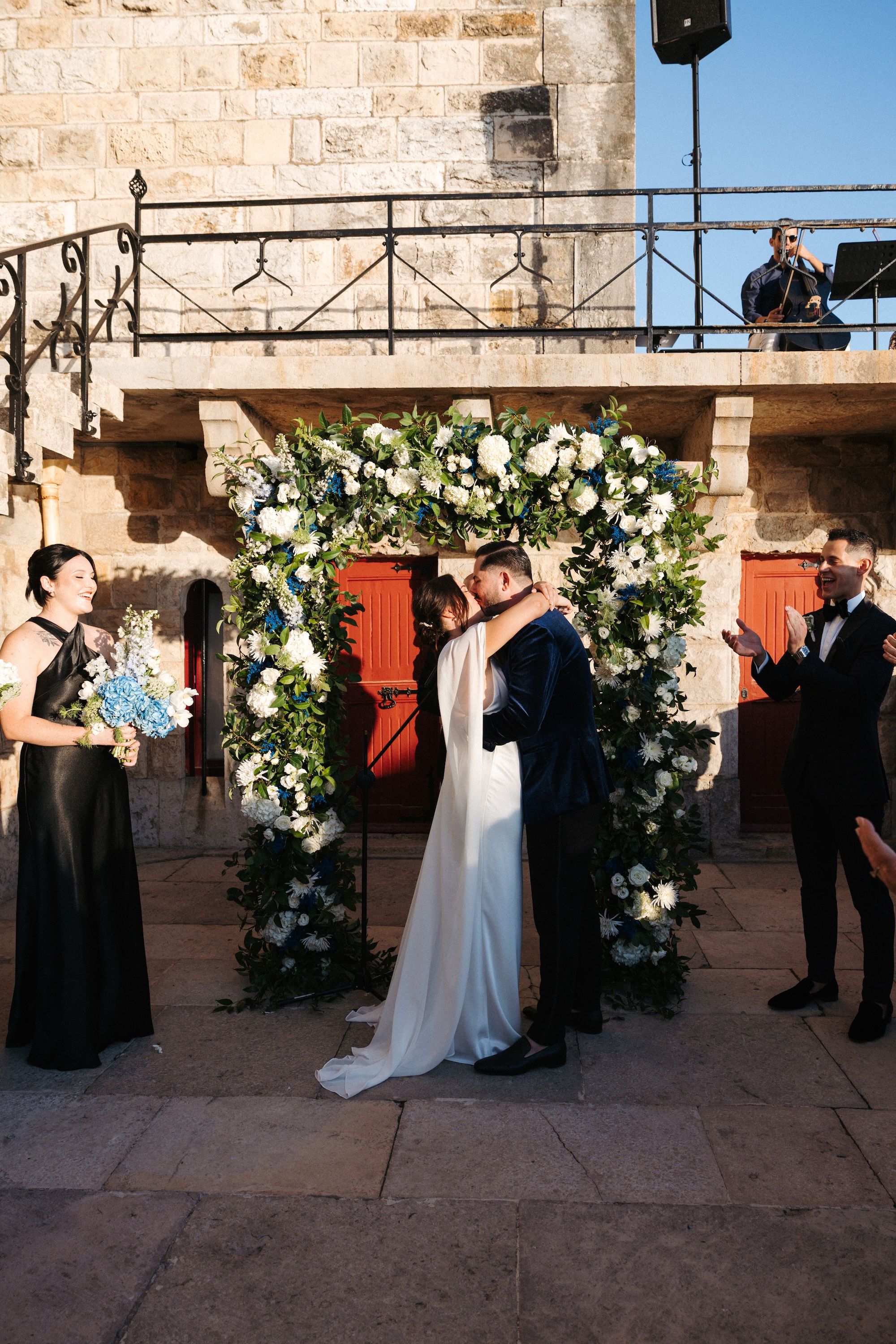 Bride and groom kiss after the ceremony of their intimate wedding in Portugal
