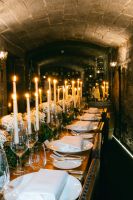 Table setting with candles and white plates arranged with a rustic chic vibe for a destination wedding in Ireland