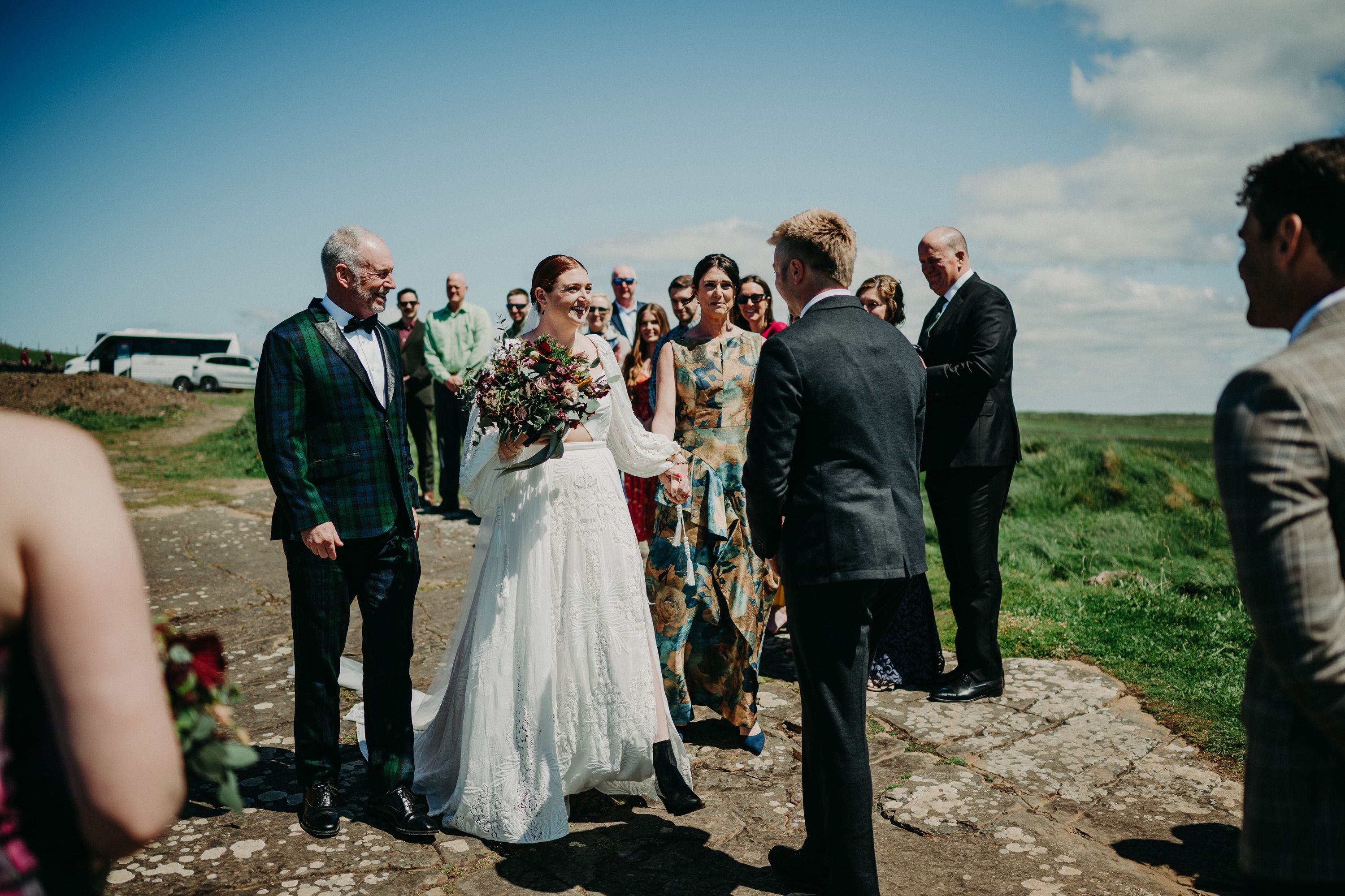 A bride seeing her groom while their friends and family look on during their intimate wedding in Ireland