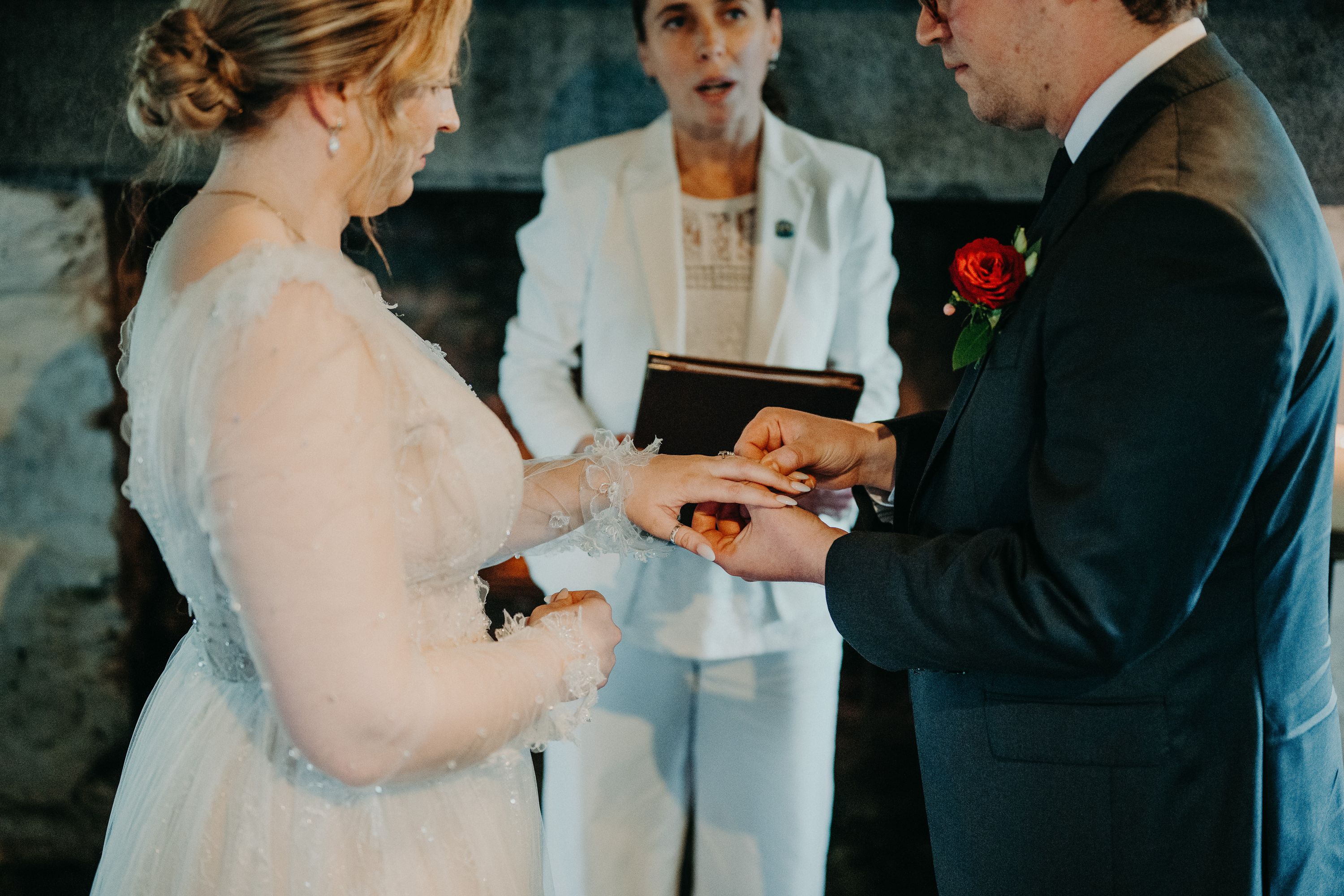 Ring exchange during a candlelit intimate wedding in Ireland ceremony