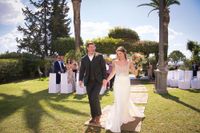 Newlyweds happily walking after the ceremony of their destination wedding in Spain in an Andalusian farmhouse in Cadiz