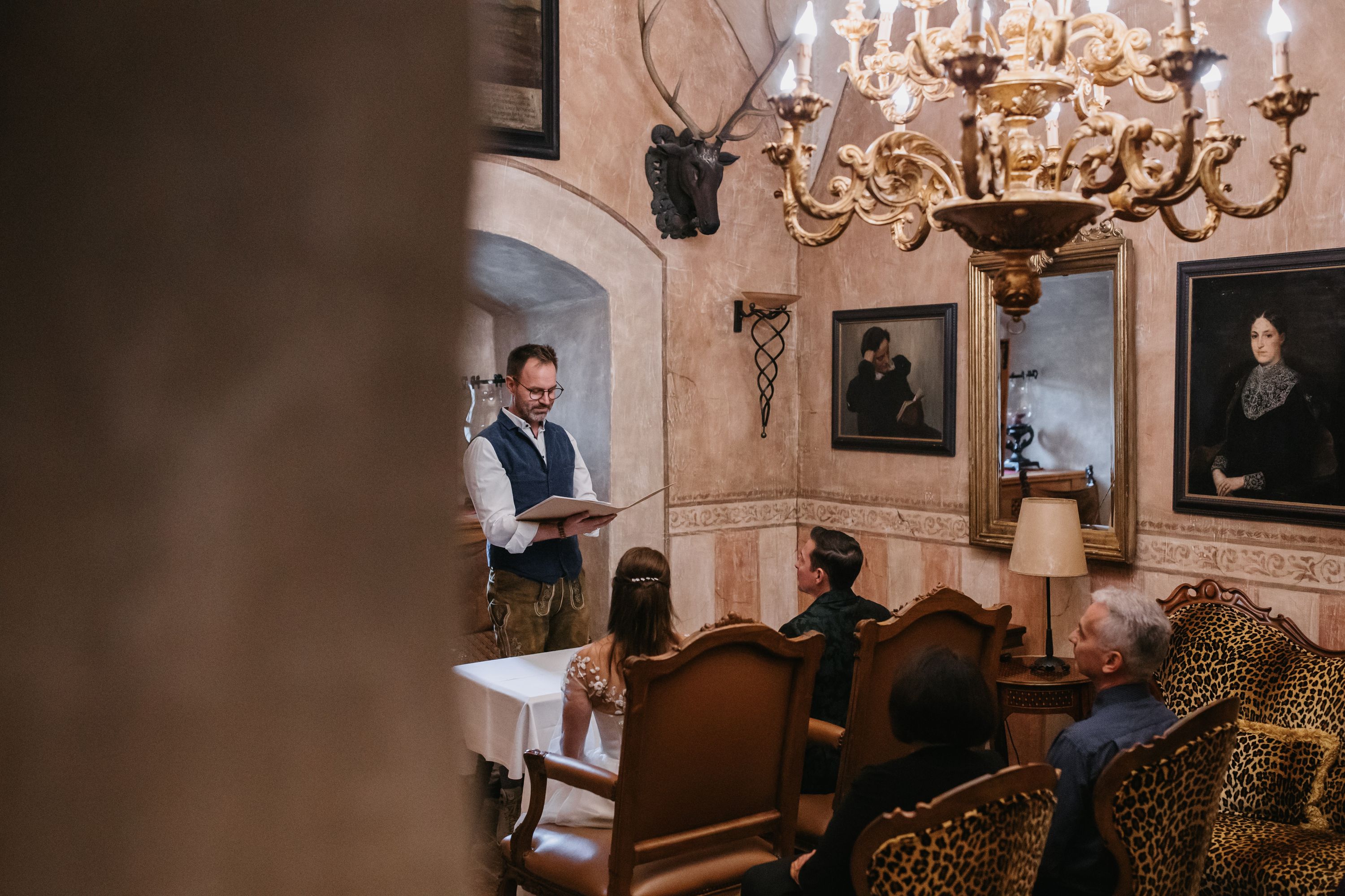 Registrar reading during an intimate civil wedding ceremony in an Austrian castle room