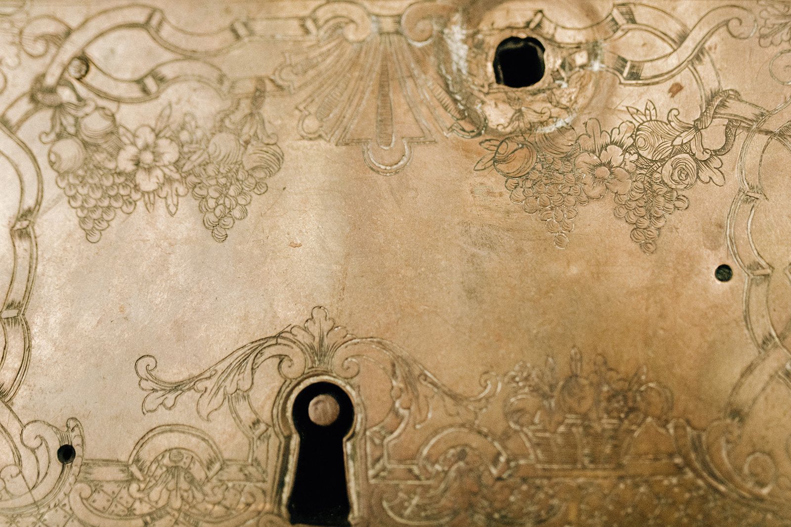 Engraved antique brass lock and keyhole on an Austrian palace door