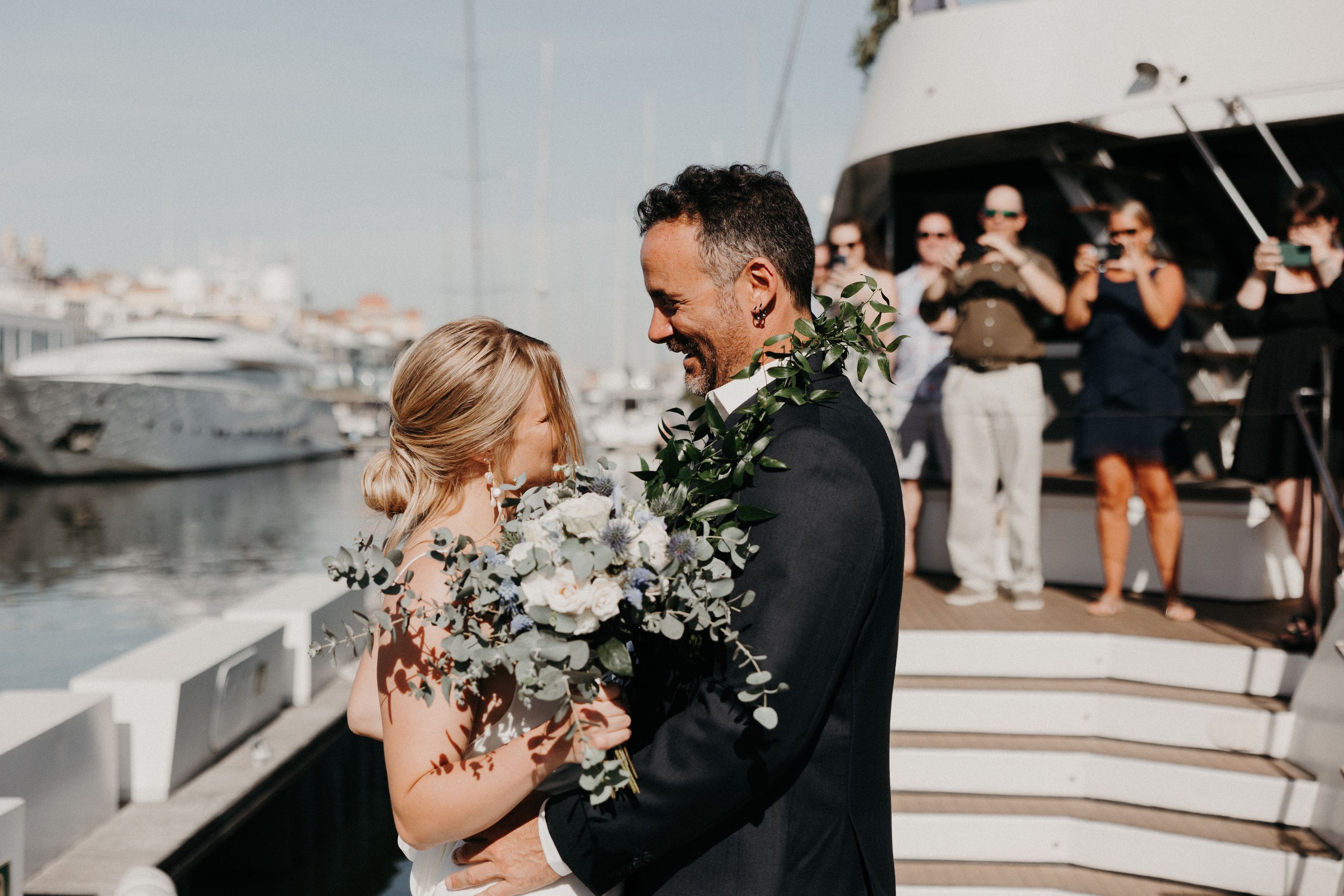 Bride and groom looking at each other while they ride a boat for their destination wedding in Portugal