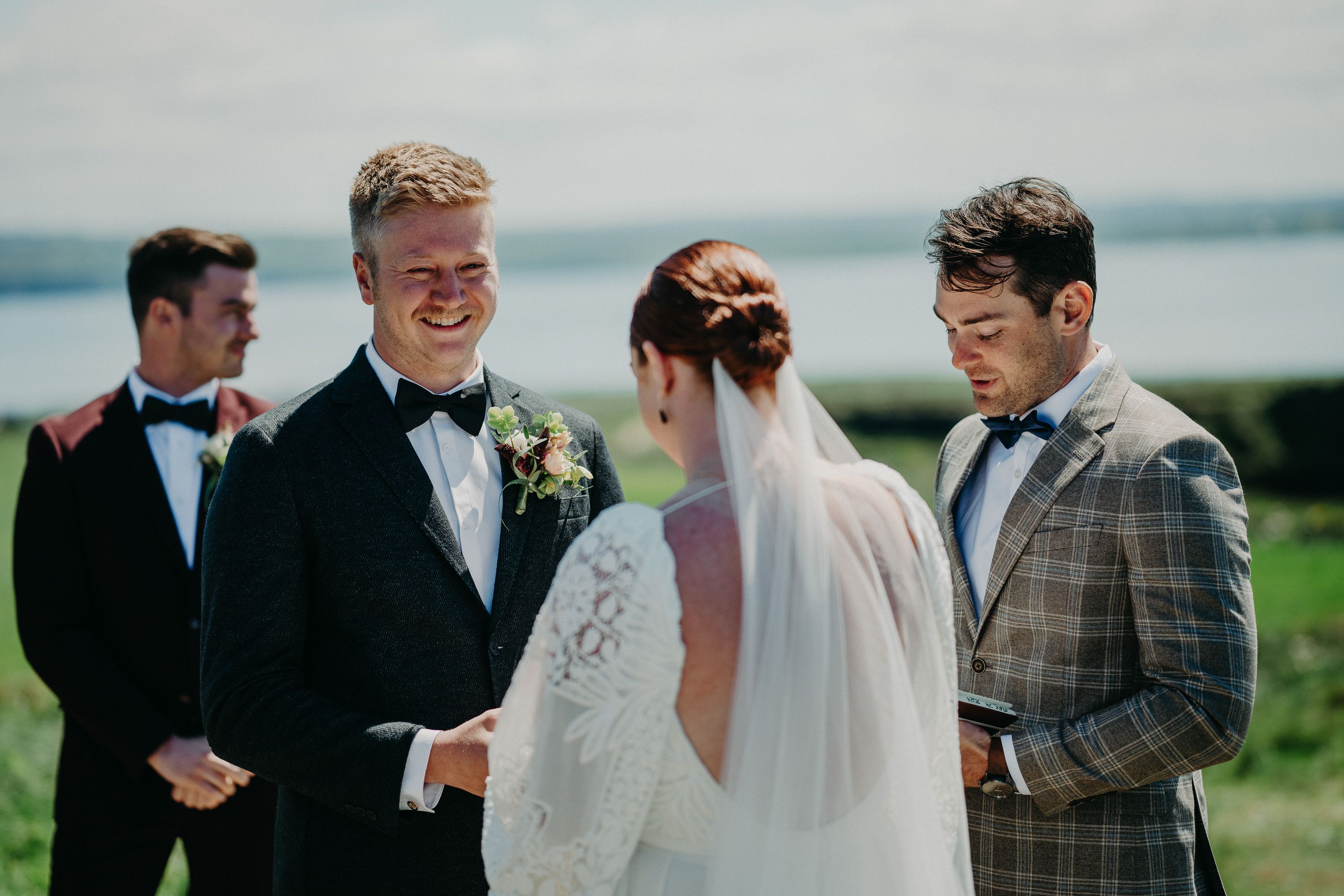 A groom lovingly gazing at his bride during a ceremony for their intimate wedding in Ireland